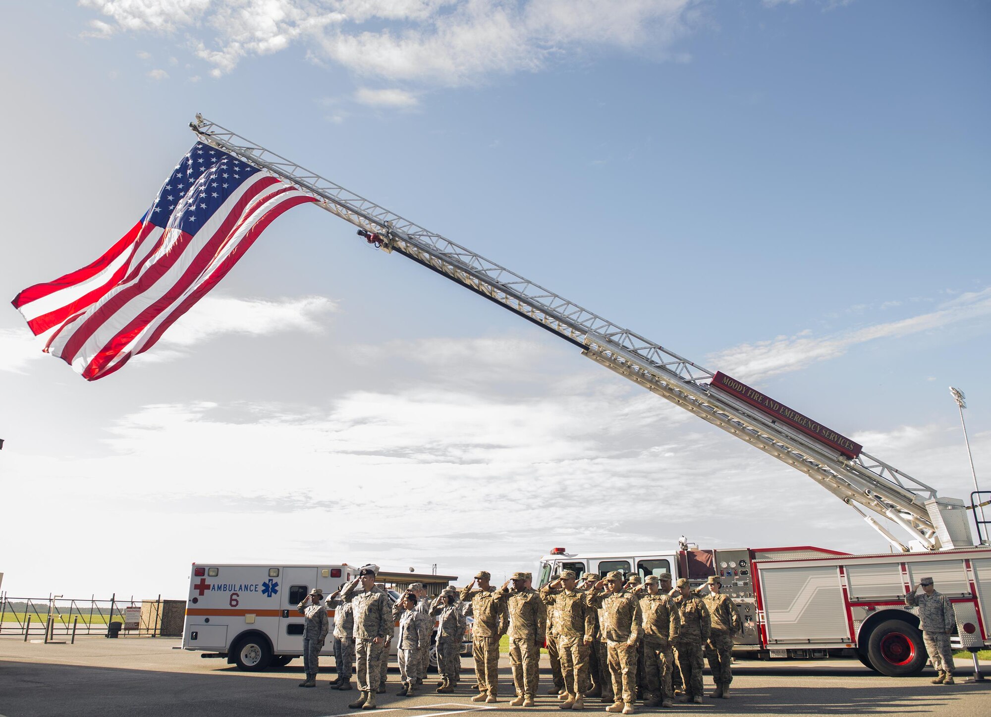 Airmen from the 105th Security Forces Squadron Air National Guard Base, N.Y., 23d SFS and 23d Civil Engineer Squadron render salutes during a 9/11 remembrance ceremony Sept. 11, 2015, at Moody Air Force Base, Ga. Defenders from the 105th SFS assisted in the 9/11 rescue efforts. (U.S. Air Force photo by Airman 1st Class Greg Nash/Released) 