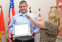 Master Sgt. Mary Perez, 433rd Aeromedical Evacuation Squadron operations flight NCO in charge, presents Christopher Borak, United States Automobile Association claims service manager, with the Patriotic Employer pin Sept. 10, 2015 at USAA headquarters in San Antonio, Texas.  Perez, a USAA claims services manager, nominated Borak for his willingness to step up and cover her position while she was deployed for six months to Ramstein Air Base, Germany. (U.S. Air Force photo by Benjamin Faske) (released)