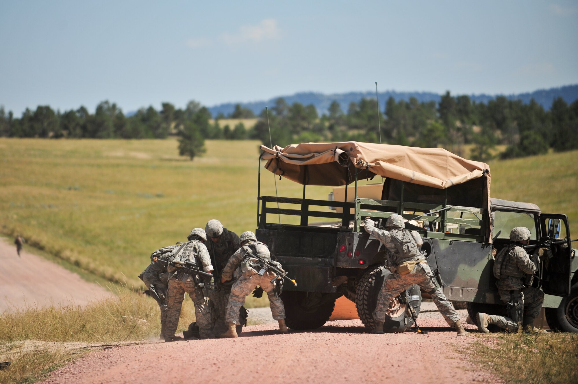 Air Force Reservists take cover and assist the simulated wounded during an ambush Aug. 11, 2015, at Camp Guernsey, Wyo. The 310th, 710th and 919th Security Forces Squadrons held a two-week field training exercise while living in field conditions.
(U.S. Air Force photos/Tech. Sgt. Nicholas B. Ontiveros)