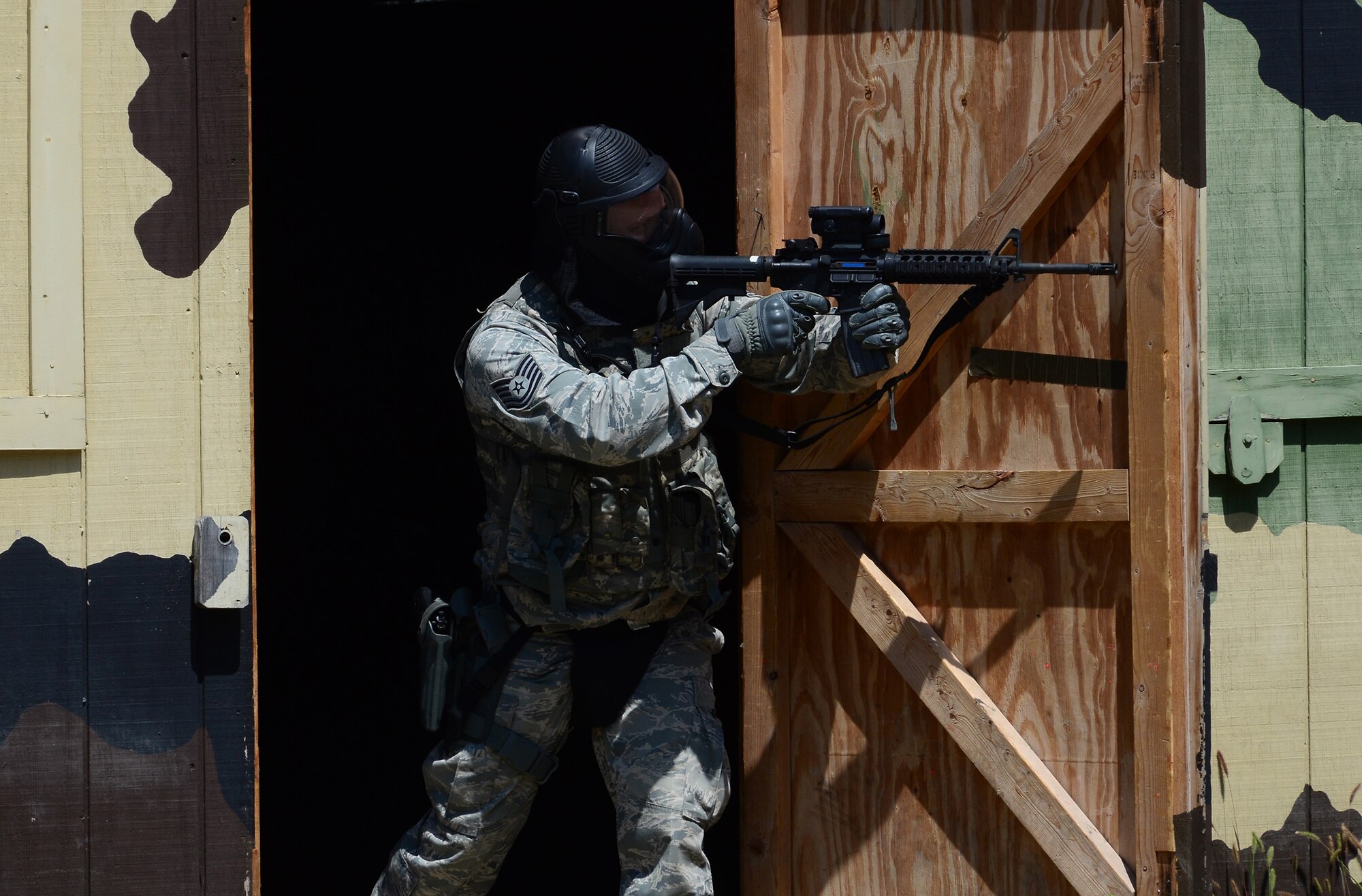 WRIGHT-PATTERSON AIR FORCE BASE, Ohio – Members of the 445th Security Forces Squadron participate in a shoot, move and communicate exercise at the Warfighter Training Center Aug. 15, 2015. The main goal of this training is to know how to shoot and use cover while moving toward a specific objective. The training incorporated firing weapons in conjunction with fire team and special weapons and tactics. ‘Simmunition’ ammunition, a soap-based dye round used to simulate real ammo was used during the training. Each scenario included objectives for both attacking and defensive forces. After each drill the instructor debriefed the members and discussed how to refine the tactics used. (U.S. Air Force photo/Senior Airman Joel McCullough)
