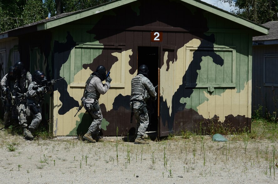 WRIGHT-PATTERSON AIR FORCE BASE, Ohio – Members of the 445th Security Forces Squadron participate in a shoot, move and communicate exercise at the Warfighter Training Center Aug. 15, 2015. The main goal of this training is to know how to shoot and use cover while moving toward a specific objective. The training incorporated firing weapons in conjunction with fire team and special weapons and tactics. ‘Simmunition’ ammunition, a soap-based dye round used to simulate real ammo was used during the training. Each scenario included objectives for both attacking and defensive forces. After each drill the instructor debriefed the members and discussed how to refine the tactics used. (U.S. Air Force photo/Senior Airman Joel McCullough)