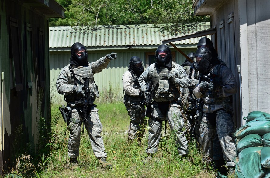 WRIGHT-PATTERSON AIR FORCE BASE, Ohio – Members of the 445th Security Forces Squadron participate in a shoot, move and communicate exercise at the Warfighter Training Center Aug. 15, 2015. The main goal of this training is to know how to shoot and use cover while moving toward a specific objective. The training incorporated firing weapons in conjunction with fire team and special weapons and tactics. ‘Simmunition’ ammunition, a soap-based dye round used to simulate real ammo was used during the training. Each scenario included objectives for both attacking and defensive forces. After each drill the instructor debriefed the members and discussed how to refine the tactics used. (U.S. Air Force photo/Senior Airman Joel McCullough)