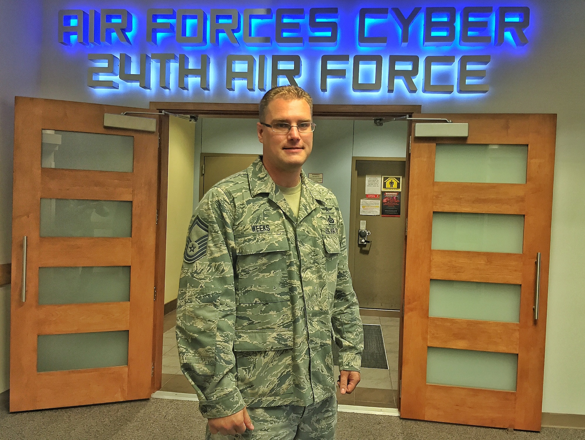 Senior Master Sgt. Michael Weeks, 854th Combat Operations Squadron, poses for a photo at the entrance to 24th Air Force, the operational warfighting organization that executes full spectrum cyberspace operations. As a cyber security engineer-analyst at the Electric Reliability Council of Texas in his civilian profession and the standards and evaluations superintendent in the U.S. Air Force Reserve, Weeks is proud to be a Citizen Airman. (Courtesy Photo)
