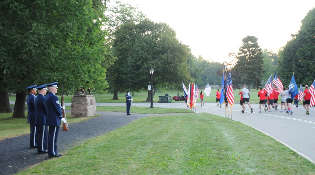 Members of the Niagara Falls Air Reserve Station Honor Guard participates in a ceremony at Delaware Park in Buffalo, New York on Sept. 11, 2015. Personnel provided a colors ceremony, rifle salute and moment of silence prior to the 3rd annual 9/11 Dawn to Dusk Moving Tribute, where runners and walkers kept one American Flag and one Flag of Honor continuously moving around the Delaware Park loop from sunrise to sunset. (U.S. Air Force photo by Staff Sgt. Matthew Burke)