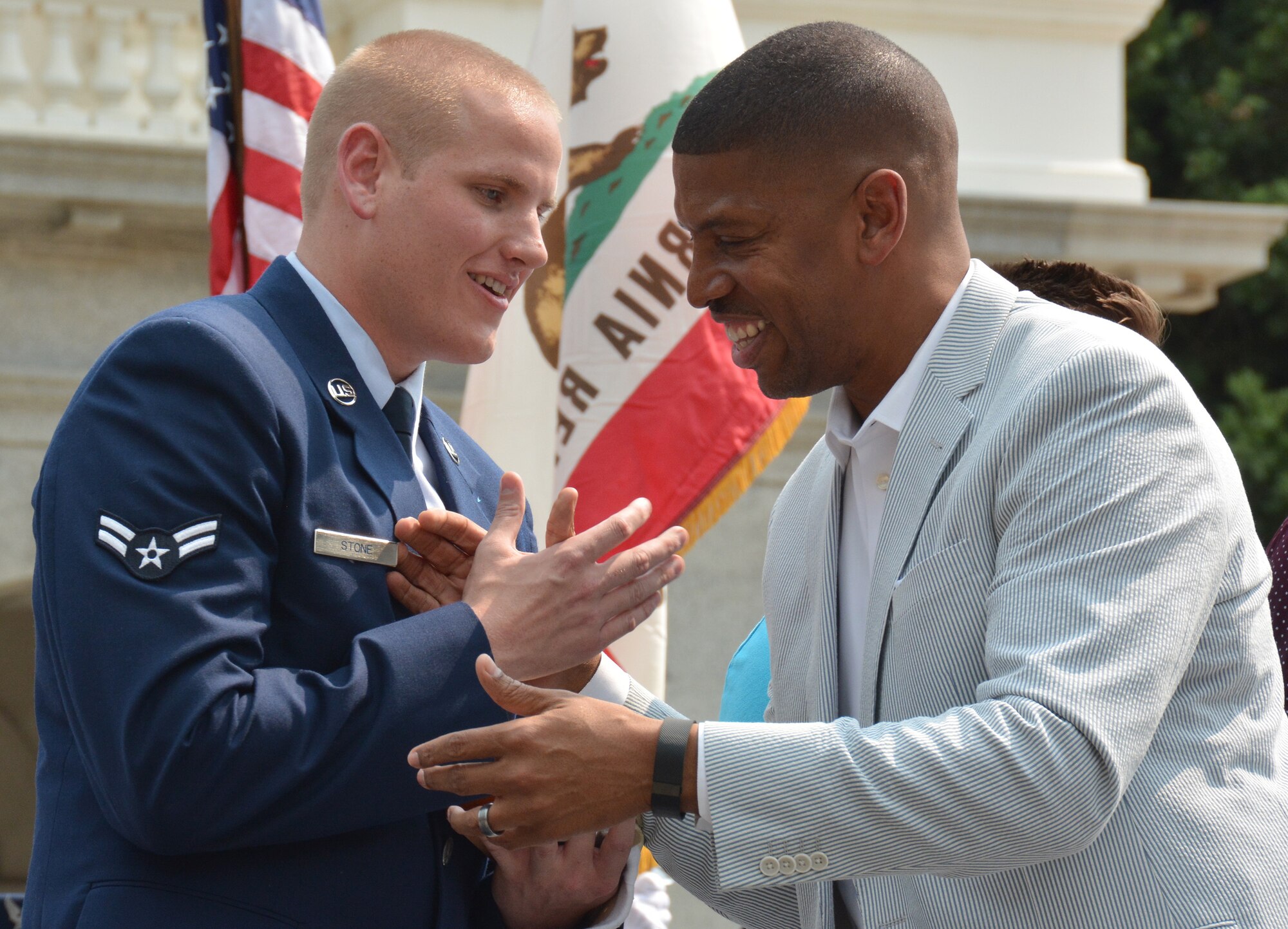 Airman 1st Class Spencer Stone is greeted by Sacramento Mayor Kevin Johnson during the Sacramento Hometown Heroes Parade and festivities at the state capitol building in downtown Sacramento, California, Sept. 11, 2015. (U.S. Air Force photo/2nd Lt. Stephen Collier)