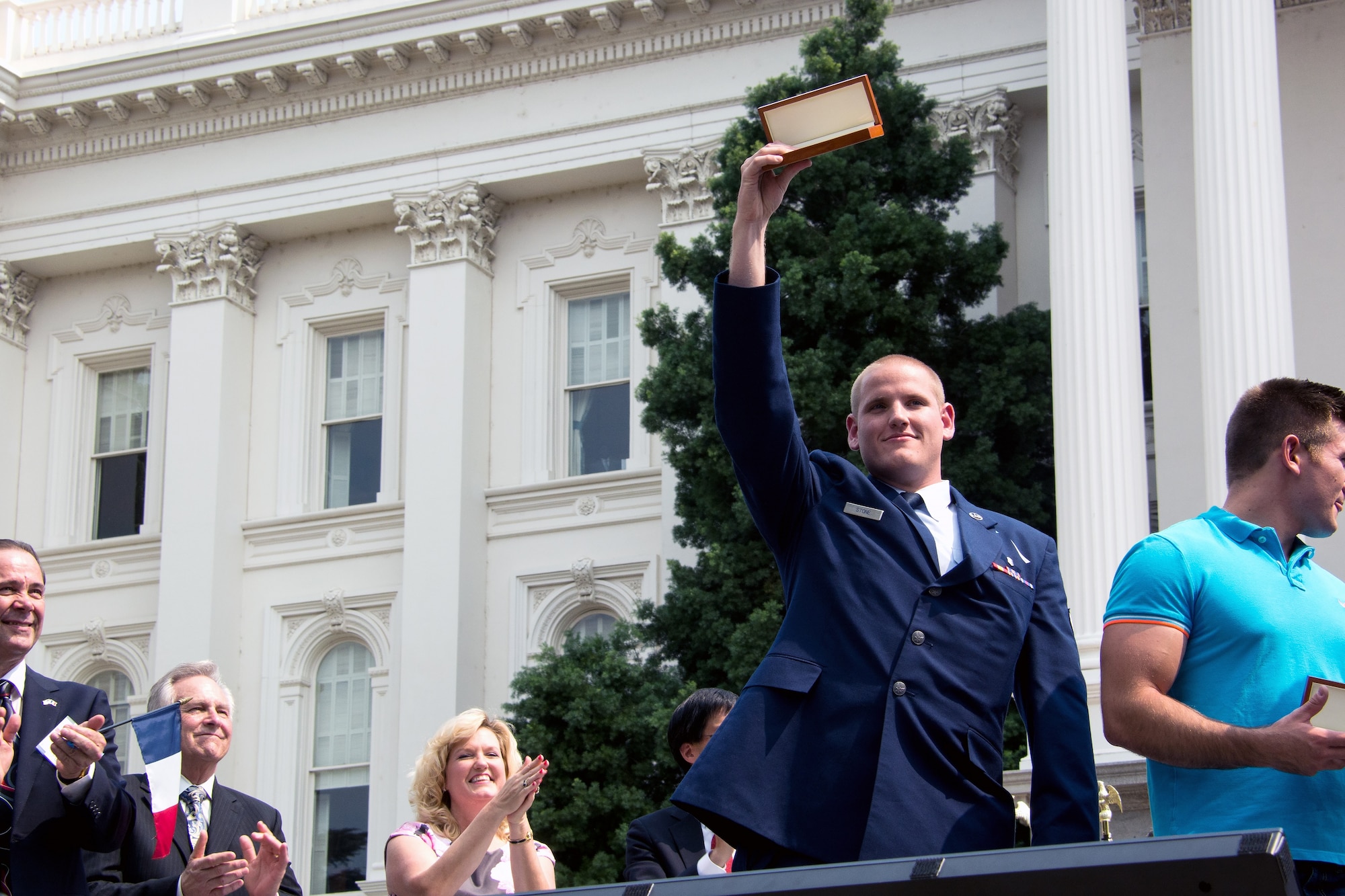 Airman 1st Class Spencer Stone receives a ceremonial key to the city from Mayor Kevin Johnson during the Sacramento Hometown Heroes Parade and festivities in Sacramento, California, Sept. 11, 2015. (U.S. Air Force photo/Senior Airman Charles Rivezzo)