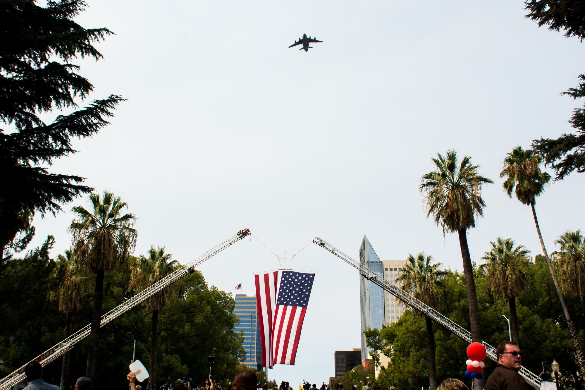 A C-17 Globemaster III from Travis Air Force Base, California, performs a flyover above the state capitol building in downtown Sacramento, California, during the Sacramento Hometown Heroes Parade and festivities, Sept. 11, 2015. Hundreds of people lined the streets during the parade to welcome home and honor Airman 1st Class Spencer Stone, Anthony Sadler and Alek Skarlatos. The trio of friends are responsible for thwarting a terrorist attack aboard a train headed toward Paris Aug. 21. (U.S. Air Force photo/Senior Airman Charles Rivezzo)