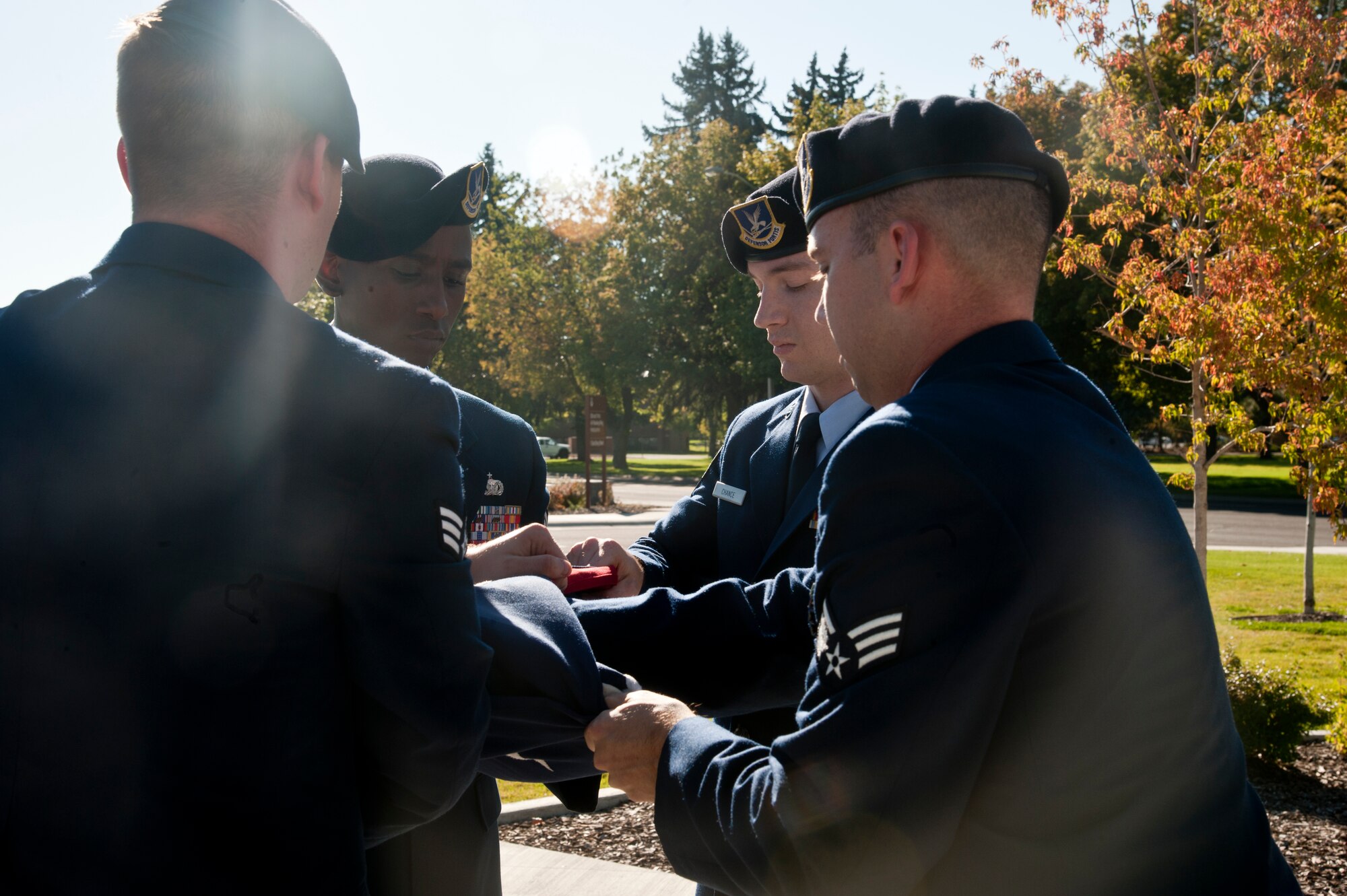 Members of the 92nd Security Forces Squadron perform a six man flag fold during the Sept. 11 retreat ceremony at Fairchild Air Force Base, Wash, Sept. 11, 2015. Members of Team Fairchild assembled in front of the 92nd Air Refueling Wing Headquarters for a formal retreat ceremony marking the 14th anniversary of Sept. 11, 2001, attacks. (U.S. Air Force photo/Airman 1st Class Taylor Bourgeous)