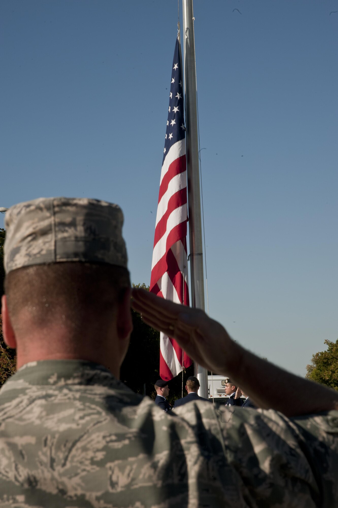 Col. Brian McDaniel, 92nd Air Refueling Wing commander, salutes during the Sept. 11 retreat ceremony at Fairchild Air Force Base, Wash, Sept. 11, 2015. The base honor guard presented a memorial wreath and wing officials spoke about the attacks on Sept. 11, 2001 before the installation flag was lowered and folded for the night. (U.S. Air Force photo/Airman 1st Class Taylor Bourgeous)