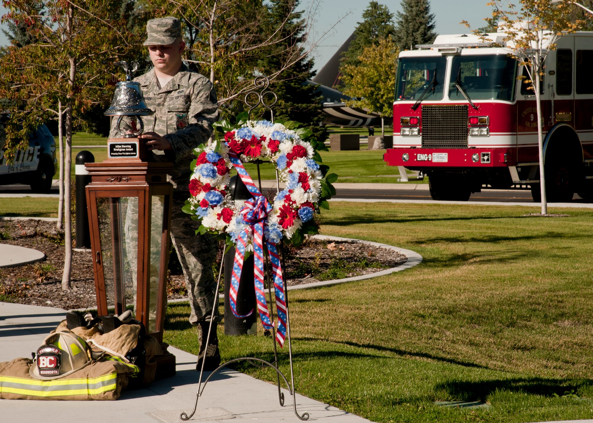 Senior Airman Bryan Schwinn, 92nd Civil Engineer Squadron firefighter, rings a ceremonial firefighter's bell at a retreat ceremony at Fairchild Air Force Base, Wash., Sept. 11, 2015. Traditionally three bells are sound in remembrance of those who can no longer respond to the call due to the Sept. 11, 2001, tragedy 14 years ago. (U.S. Air Force photo/Airman 1st Class Taylor Bourgeous)