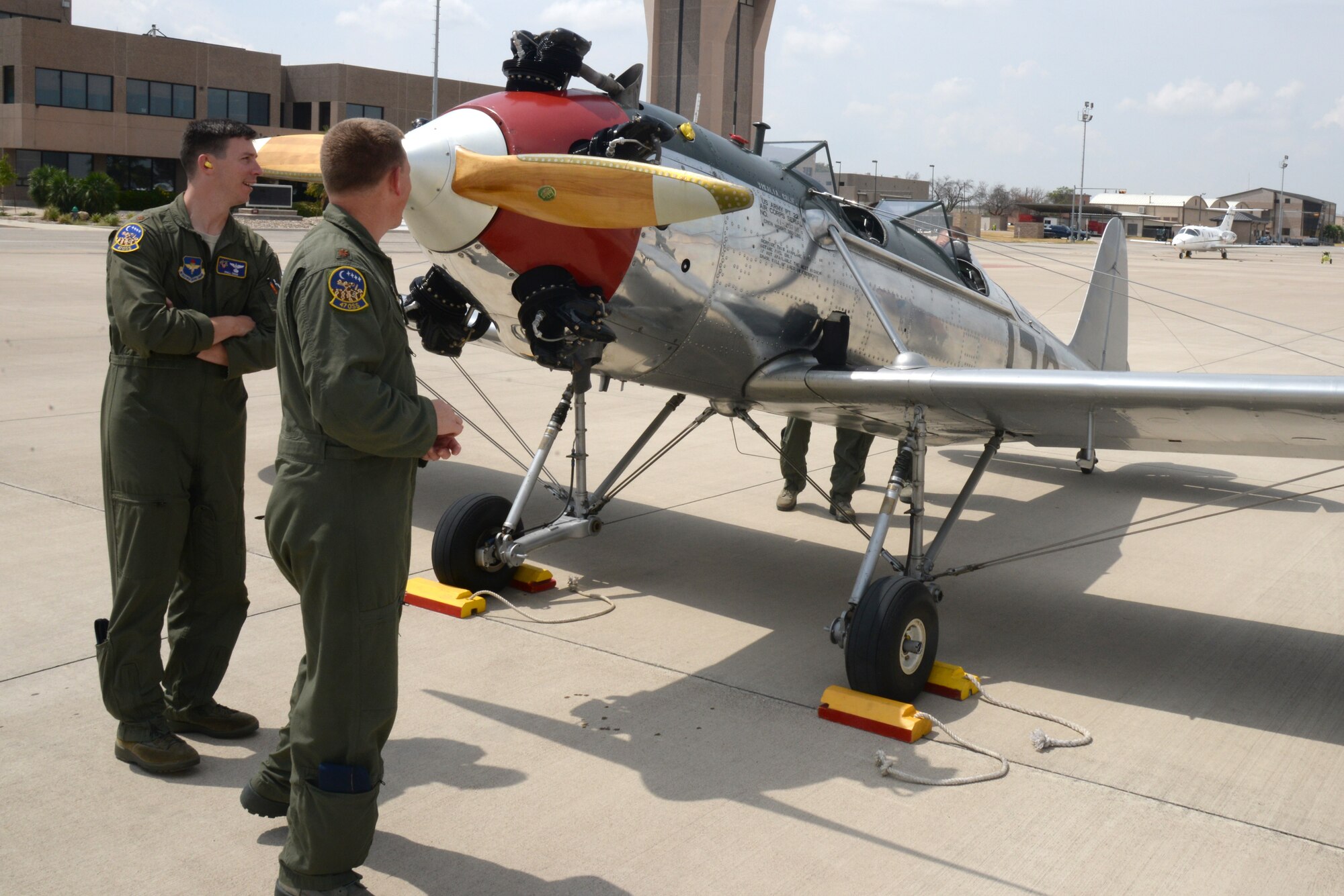 Maj. Nicholas Browning and Maj. Phillip Drew, 47th Operational Support Squadron assistant directors of operations, check out a Ryan PT-22 on Laughlin Air Force Base, Texas, Sept. 10, 2015. The PT-22 was one of the original trainers for the Army Air Corps in the early 1940’s, and has since been replaced by trainer models such as the T-6 Texan II. (U.S. Air Force Photo by Airman 1st Class Brandon May) (Released)