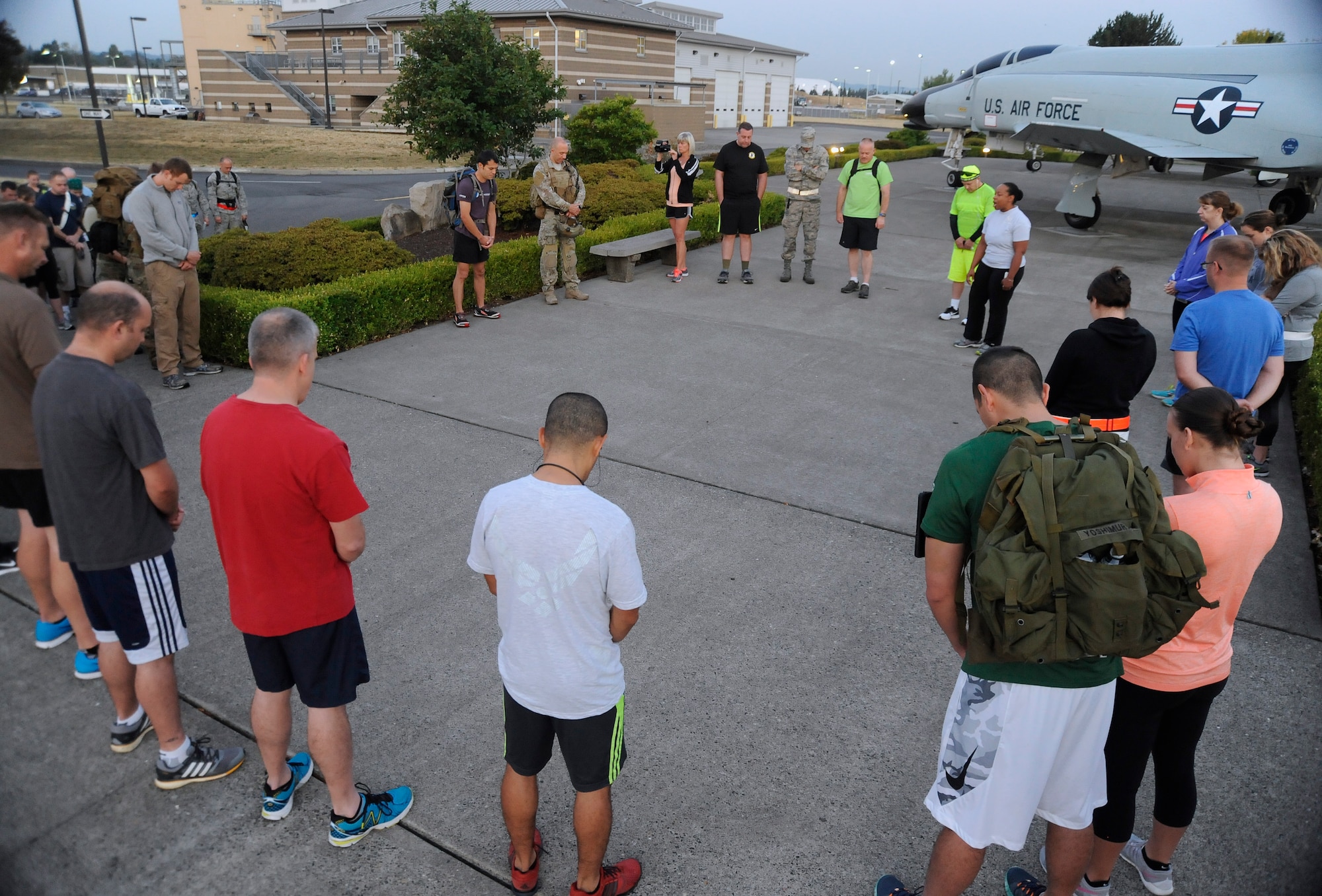 Participants for the ‘Ruck, Run and Walk’ gather for a morning message and prayer by Maj. Trisa Kelly, 142nd Fighter Wing Chaplain, Sept. 11, 2015, Portland Air National Guard Base, Ore. (U.S. Air National Guard photo by Tech. Sgt. John Hughel, 142nd Fighter Wing Public Affair/Released)