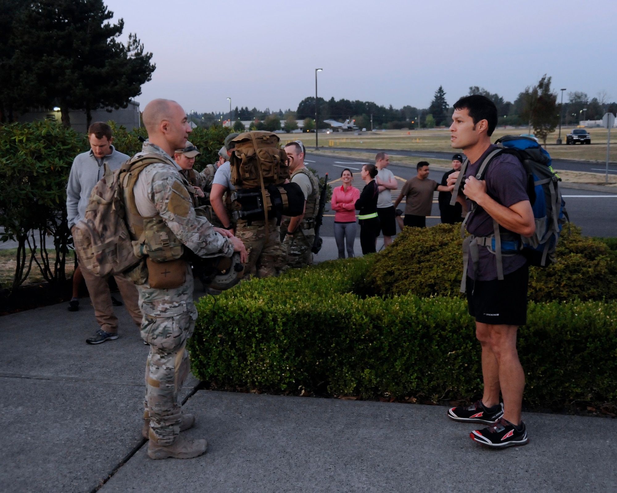 Air Force Lt. Col. John Graver, 304th Rescue Squadron commander, left, and Lt. Col. Frank Page, 142nd Fighter Wing Inspection Team Leader, right, discuss the route for the ‘Ruck, Run and Walk’ event, Sept. 11, 2015, Portland Air National Guard Base, Ore. (U.S. Air National Guard photo by Tech. Sgt. John Hughel, 142nd Fighter Wing Public Affair/Released)