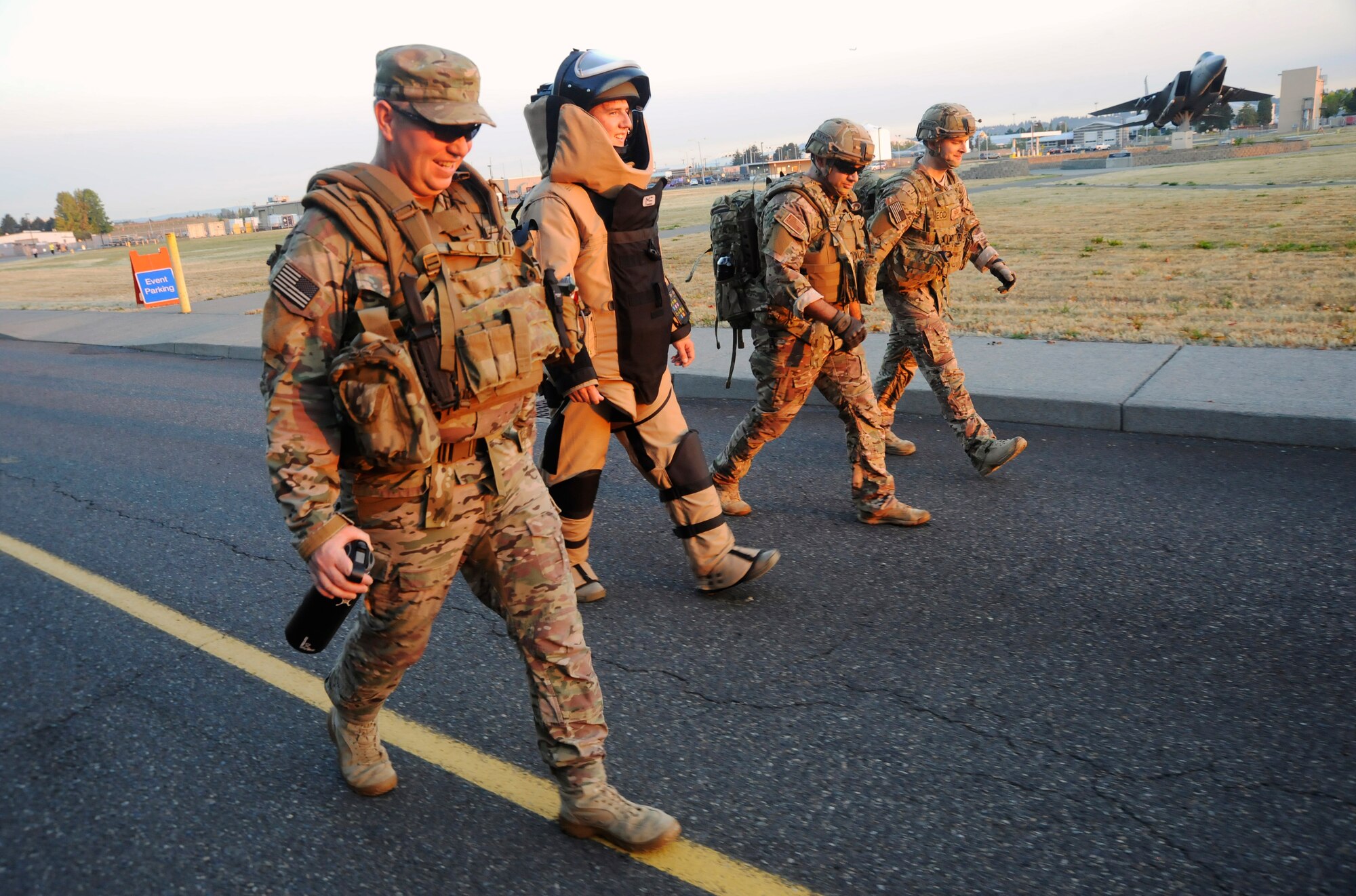 Four Explosive Ordinance Disposal members of the 142nd Fighter Wing Civil Engineer Squadron walk together along the ‘Ruck, Run and Walk’, route at the Portland Air National Guard Base, Ore., Sept. 11, 2015. (U.S. Air National Guard photo by Tech. Sgt. John Hughel, 142nd Fighter Wing Public Affair/Released)
