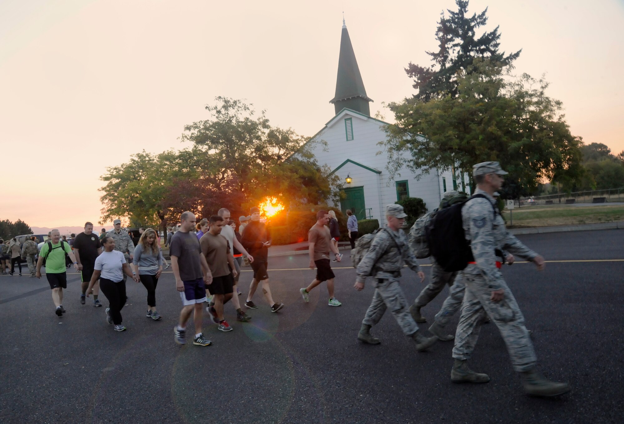 Participants from the 142nd Fighter Wing and 304th Rescue Squadron move along the route of the ‘Ruck, Run and Walk’, and pass the air base chapel at Portland Air National Guard Base, Ore., Sept 11, 2015. (U.S. Air National Guard photo by Tech. Sgt. John Hughel, 142nd Fighter Wing Public Affair/Released)