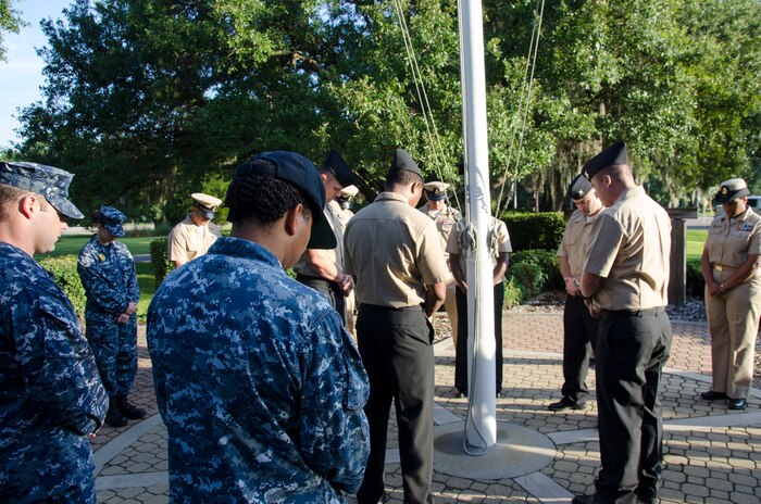 Sailors bow their heads during a moment of silence in remembrance of the 9/11 terrorist attacks, at Joint Base Charleston – Weapons Station, S.C., September 11, 2015. (U.S. Air Force photo/Staff Sgt. AJ Hyatt)