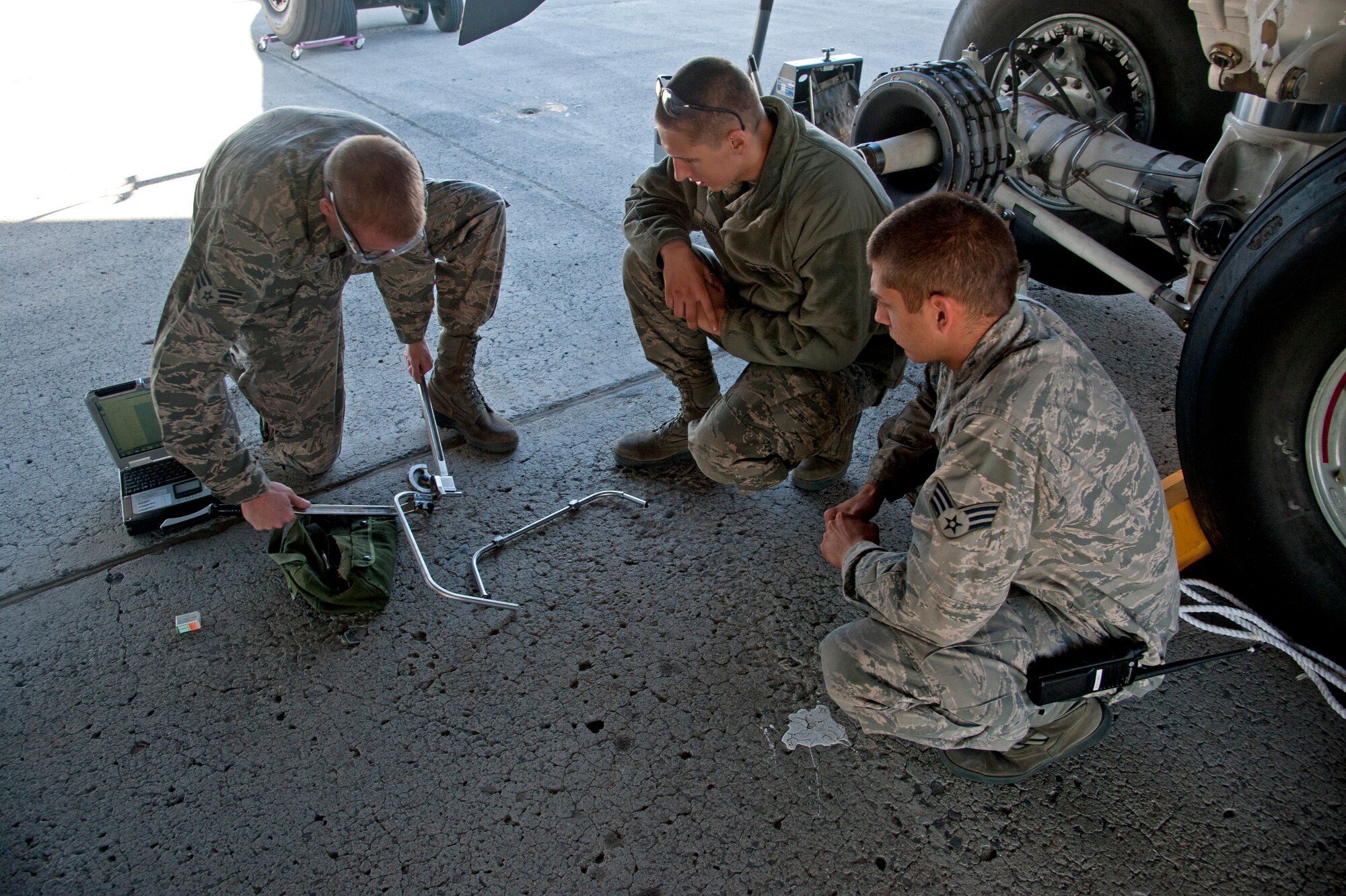 Senior Airman Matthew Jones and Airman 1st Class Zachary Dusek, 92nd Maintenance Squadron aircraft structural maintenance specialists, work alongside Senior Airman Steven Richichi, 92nd Aircraft Maintenance Squadron crew chief, while fitting a piece of steel to a KC-135 Stratotanker Sept. 9, 2015, at Fairchild Air Force Base, Wash. MXS and AMXS work closely on a day-to-day basis ensuring aircraft is fully operational. (U.S. Air Force photo/Airman 1st Class Mackenzie Richardson)