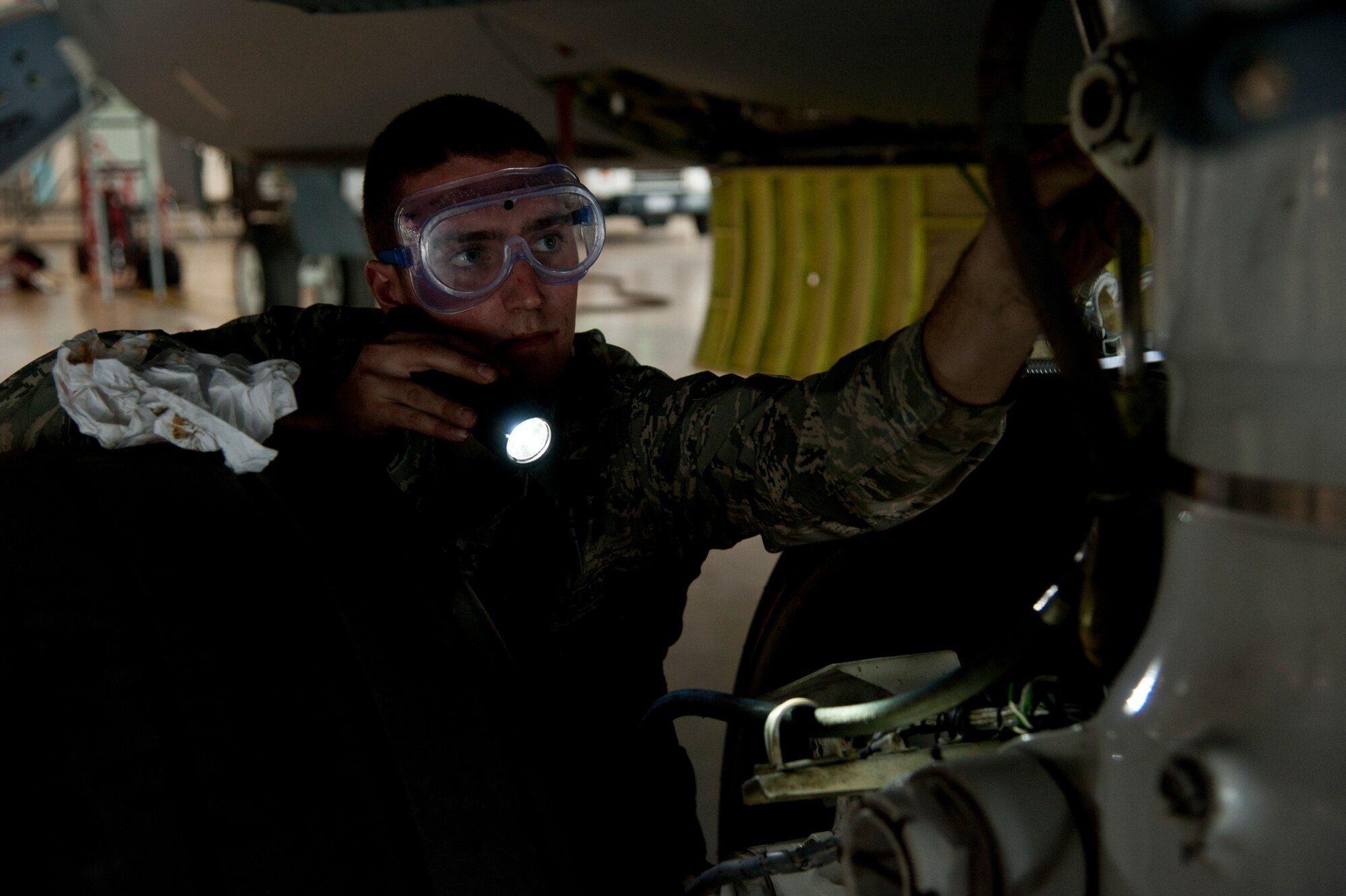 Airman Andrew Kowalski, 92nd Aircraft Maintenance Squadron crew chief, inspects a KC-135 Stratotanker during a 900-hour inspection Sept. 9, 2015, at Fairchild Air Force Base, Wash. During  900-hour inspections, all of the panels of the aircraft are removed and the gear is checked thoroughly to include landing gear, ensuring the aircraft is fully operational. (U.S. Air Force photo/Airman 1st Class Mackenzie Richardson)
