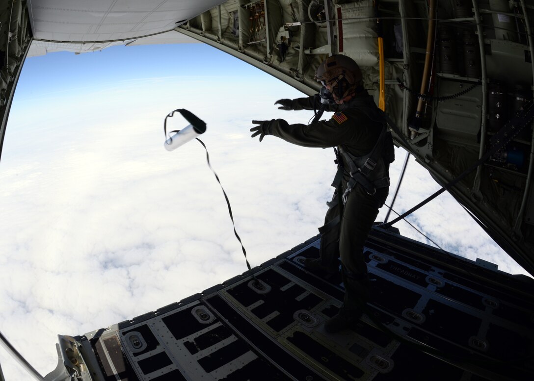 U.S. Air Force Senior Airman Jeremie Anderson, 67th Special Operations Squadron MC-130J Commando II loadmaster, launches an LUU-4/B flare from the back of an MC-130 J during a training mission Sept. 8, 2015, over the North Sea. Anderson launched flares for 48th Fighter Wing F-15 pilots to track, target and destroy. The 67th SOS and the 48th FW organized the two-day mission in order to provide realistic targeting training for F-15 pilots. Although the primary use of the flares are for search and rescue missions, instead they were used for targeting practice due to an upcoming expiration date. (U.S. Air Force photo by Tech. Sgt. Krystie Martinez/Released)