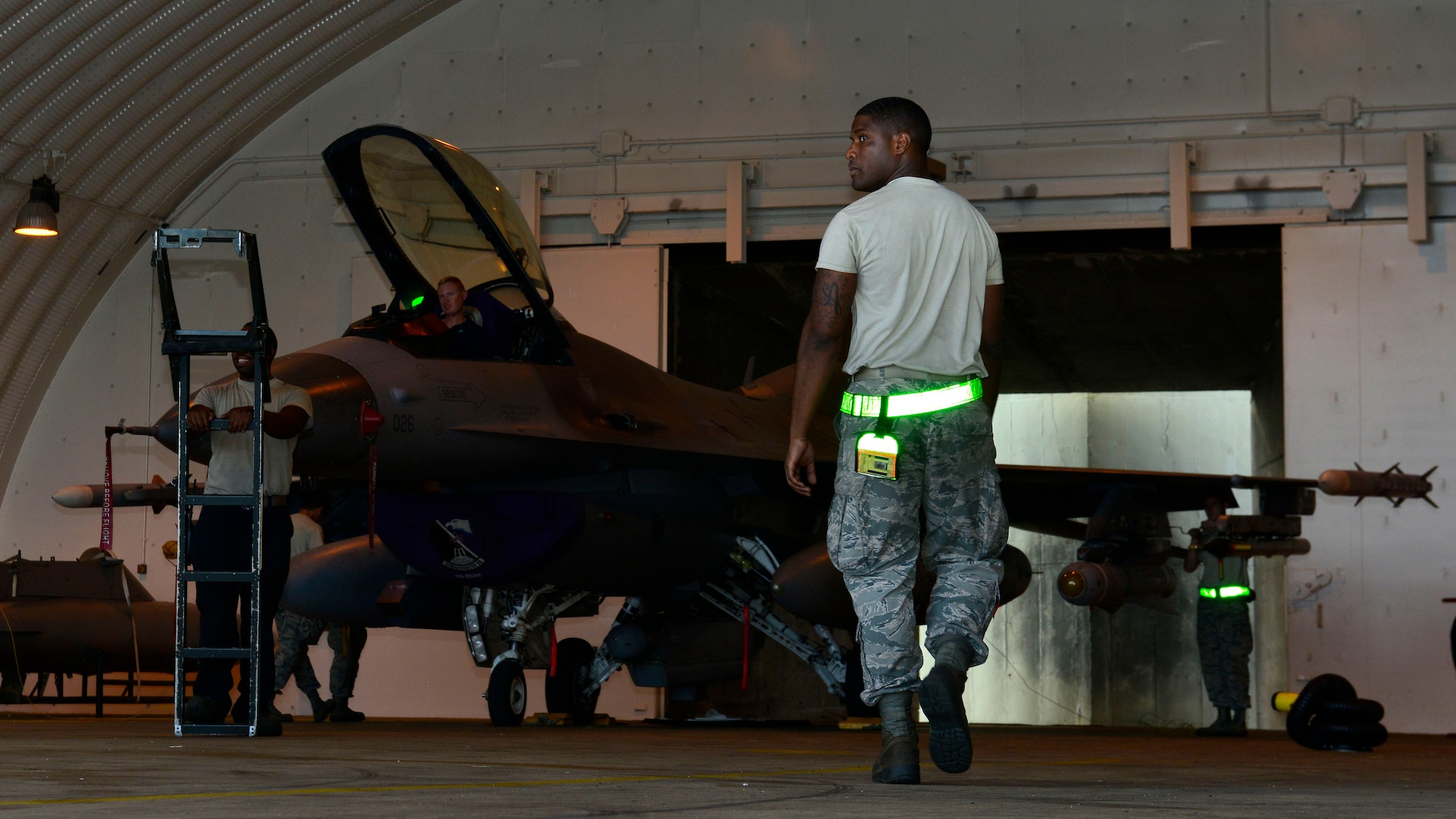 U.S. Air Force Airman 1st Class Keitha Whitaker, 31st Aircraft Maintenance Squadron crew chief, works with a team of Airmen to tow an F-16 Fighting Falcon, Sept. 9, 2015, at Aviano Air Base, Italy. Airmen from several maintenance shops worked together to prepare aircraft for flights. (U.S. Air Force photo by Airman 1st Class Cary Smith/Released)