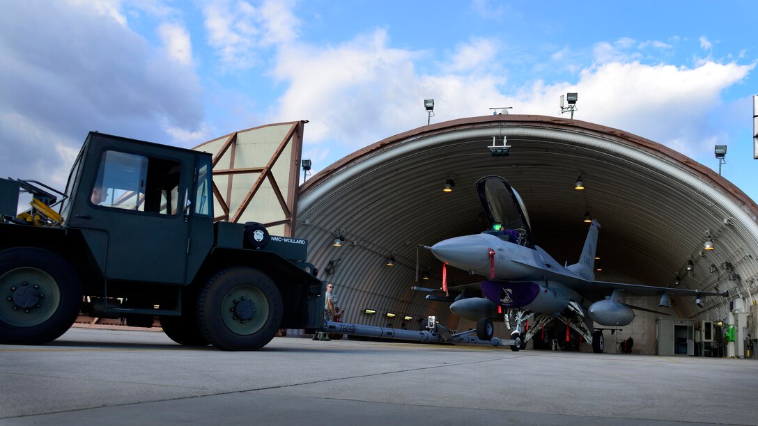 U.S. Air Force crew chiefs from the 31st Aircraft Maintenance Squadron tow an F-16 Fighting Falcon, Sept. 9, 2015, at Aviano Air Base, Italy. Crew chiefs work around the clock to ensure F-16s are mechanically ready to fly. (U.S. Air Force photo by Airman 1st Class Cary Smith/Released)