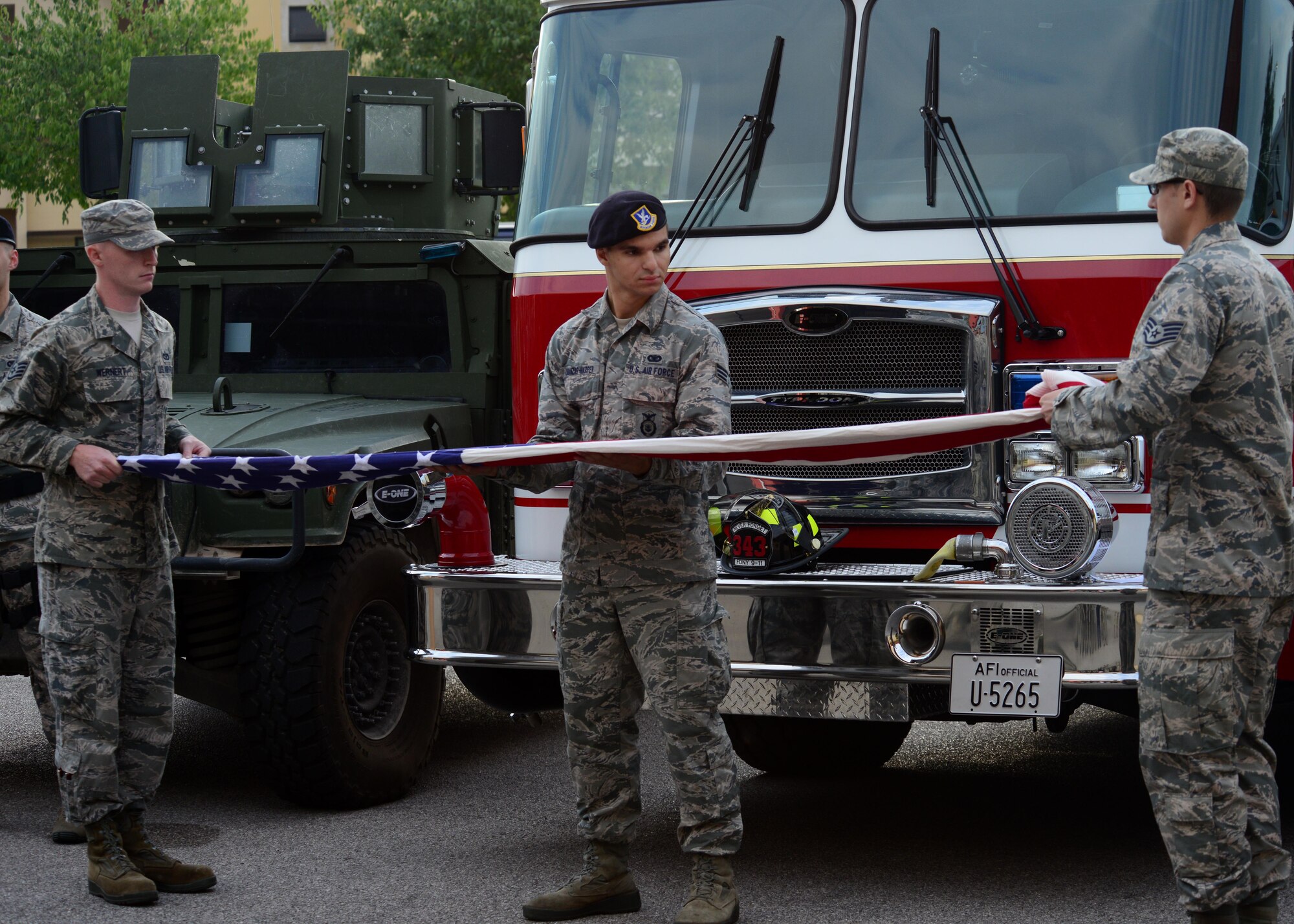 U.S. Air Force Airmen fold the U.S. flag during a 9/11 ceremony Sept. 11, 2015, at Aviano Air Base, Italy.  The ceremony was held to commemorate the 14th anniversary of the Sept. 11, 2001 terrorist attacks that claimed the lives of approximately 3,000 innocent people at the World Trade Center, Shanksville, Penn., and the Pentagon. (U.S. Air Force photo by Staff Sgt. Evelyn Chavez/Released)