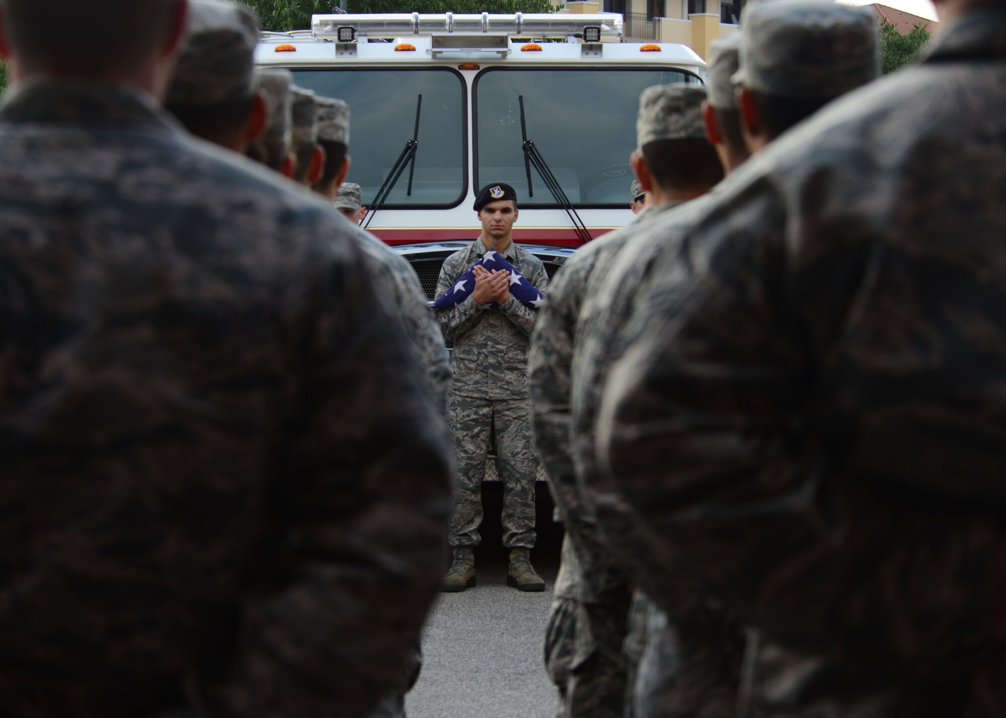 U.S. Air Force Senior Airman Brandon Almanzar-Harper, 31st Secruity Forces Squadron defender, holds the U.S. flag during a 9/11 ceremony Sept. 11, 2015, at Aviano Air Base, Italy.  The ceremony was held to commemorate the 14th anniversary of the Sept. 11, 2001 terrorist attacks that claimed the lives of approximately 3,000 innocent people at the World Trade Center, Shanksville, Penn., and the Pentagon. (U.S. Air Force photo by Staff Sgt. Evelyn Chavez/Released)