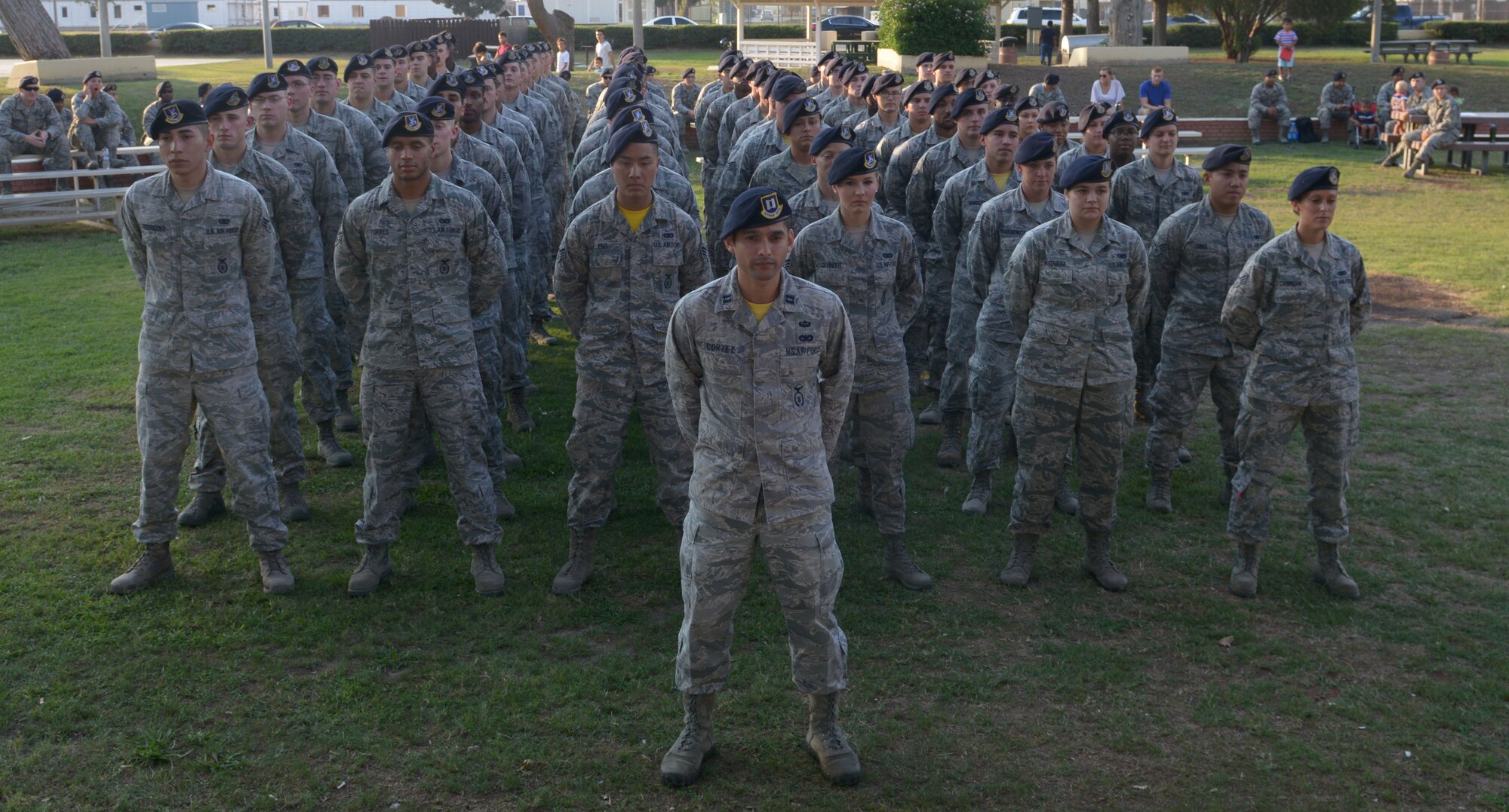 A flight of 39th Security Forces Squadron defenders stand in formation prior to a Bridge Ceremony Aug. 28, 2015, at Incirlik Air Base, Turkey. The formation was comprised of Airmen before the squadron’s newly selected staff sergeants were called out of formation to cross a stage and have a red ribbon tied to their arms before joining a flight of NCOs. (U.S. Air Force photo by Senior Airman Krystal Ardrey/Released)