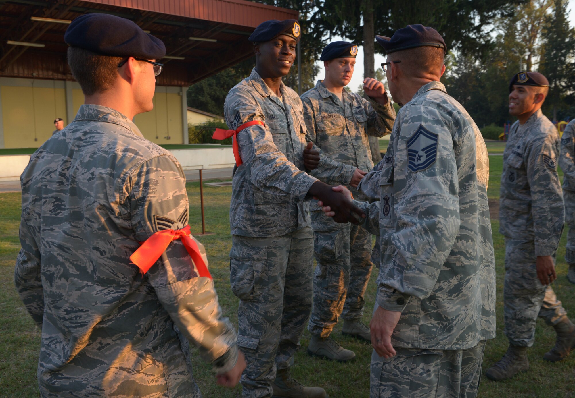 Leadership from the 39th Security Forces Squadron shake hands with senior airmen after a Bridge Ceremony Aug. 28, 2015, at Incirlik Air Base, Turkey. The ceremony, which was resembled promotion ceremonies from the U.S.’s earliest militia, was held to honor senior airmen who were newly selected to promote to staff sergeant. (U.S. Air Force photo by Senior Airman Krystal Ardrey/Released)