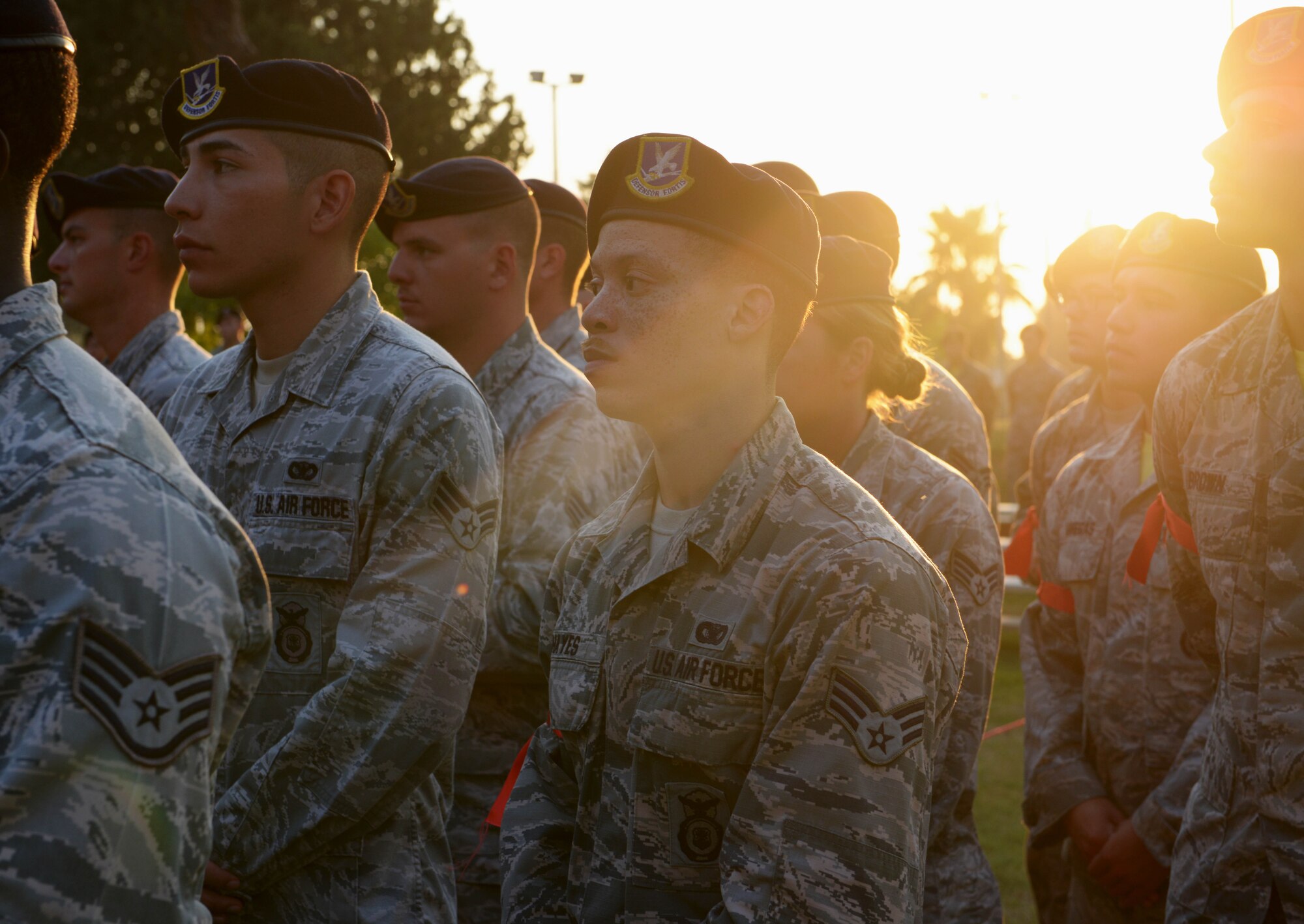 Senior Airman DeMarcus Hayes, 39th Security Forces Squadron assistant NCO in-charge of armory, stands behind non-commissioned officers from his squadron following a Bridge Ceremony Aug. 28, 2015, at Incirlik Air Base, Turkey. During the ceremony, the newly selected staff sergeant had a red ribbon tied around their arm before joining a flight of NCOs, thus signifying their transition to the NCO corps.. (U.S. Air Force photo by Senior Airman Krystal Ardrey/Released)