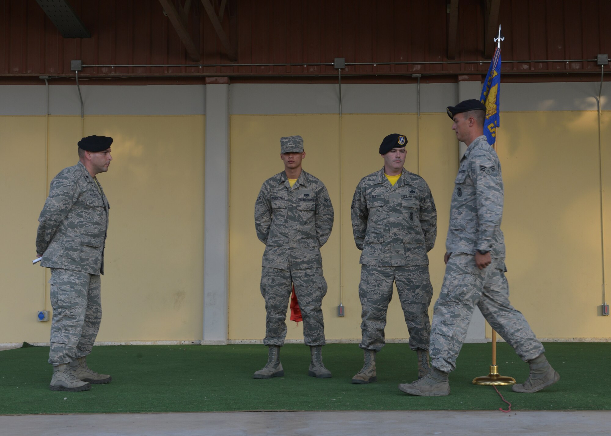 Senior Airman Michael Logan, 39th Security Forces Squadron NCO in-charge of confinement, steps across a rope symbolizing his transition from the Airman tier to the NCO tier during a Bridge Ceremony Aug. 28, 2015, at Incirlik Air Base, Turkey. Logan was one of 24 senior airmen from the 39th SFS who were selected for promotion to staff sergeant during the 2015 promotion cycle. (U.S. Air Force photo by Senior Airman Krystal Ardrey/Released) 