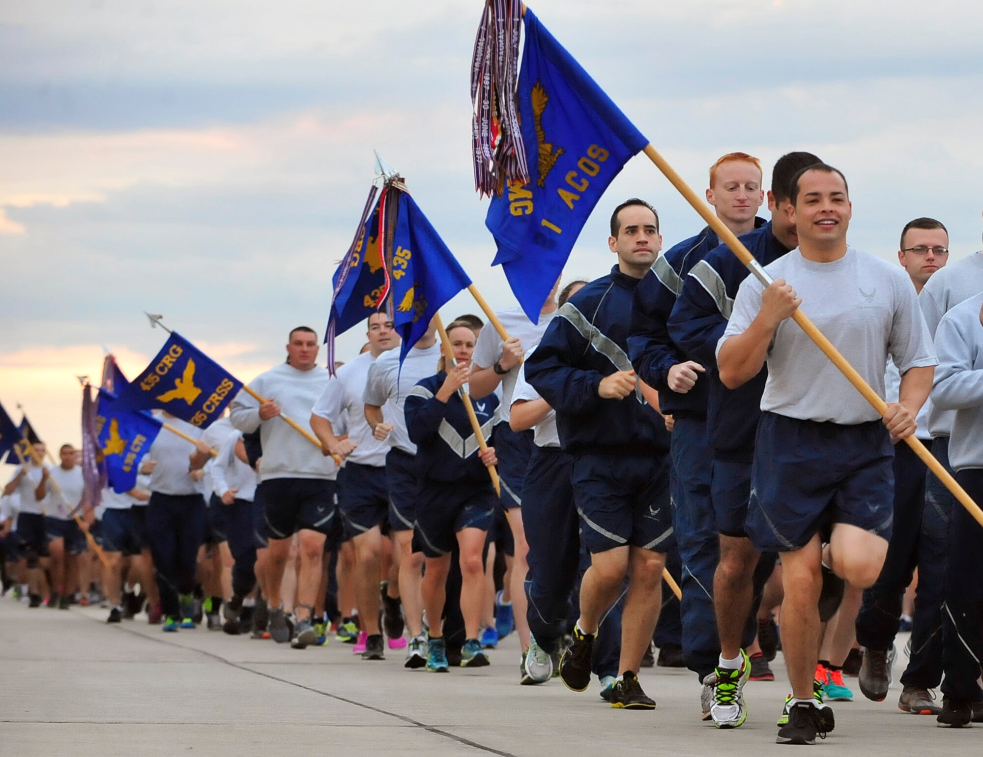 Airmen display their guidon as they run in formation during the third tri-wing run of the year, Sept. 3, 2015, at Ramstein Air Base, Germany. The guidon is a military tradition and a representation of the unit which serves as the rally point for Airmen to fall into formation. (U.S. Air Force photo/Airman 1st Class Larissa Greatwood)