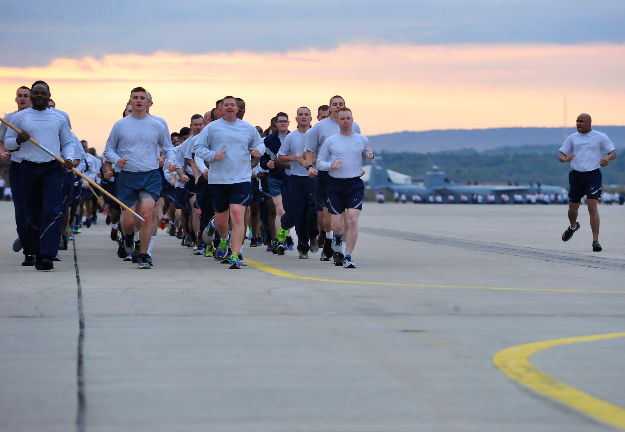 Airmen from the 86th Comptroller Squadron run in formation while singing jodies during the third tri-wing run of the year, Sept. 3, 2015, at Ramstein Air Base, Germany. The regularly scheduled tri-wing runs are one of the few times where all three wings on Ramstein come together to form Team Ramstein. (U.S. Air Force photo/Airman 1st Class Larissa Greatwood)