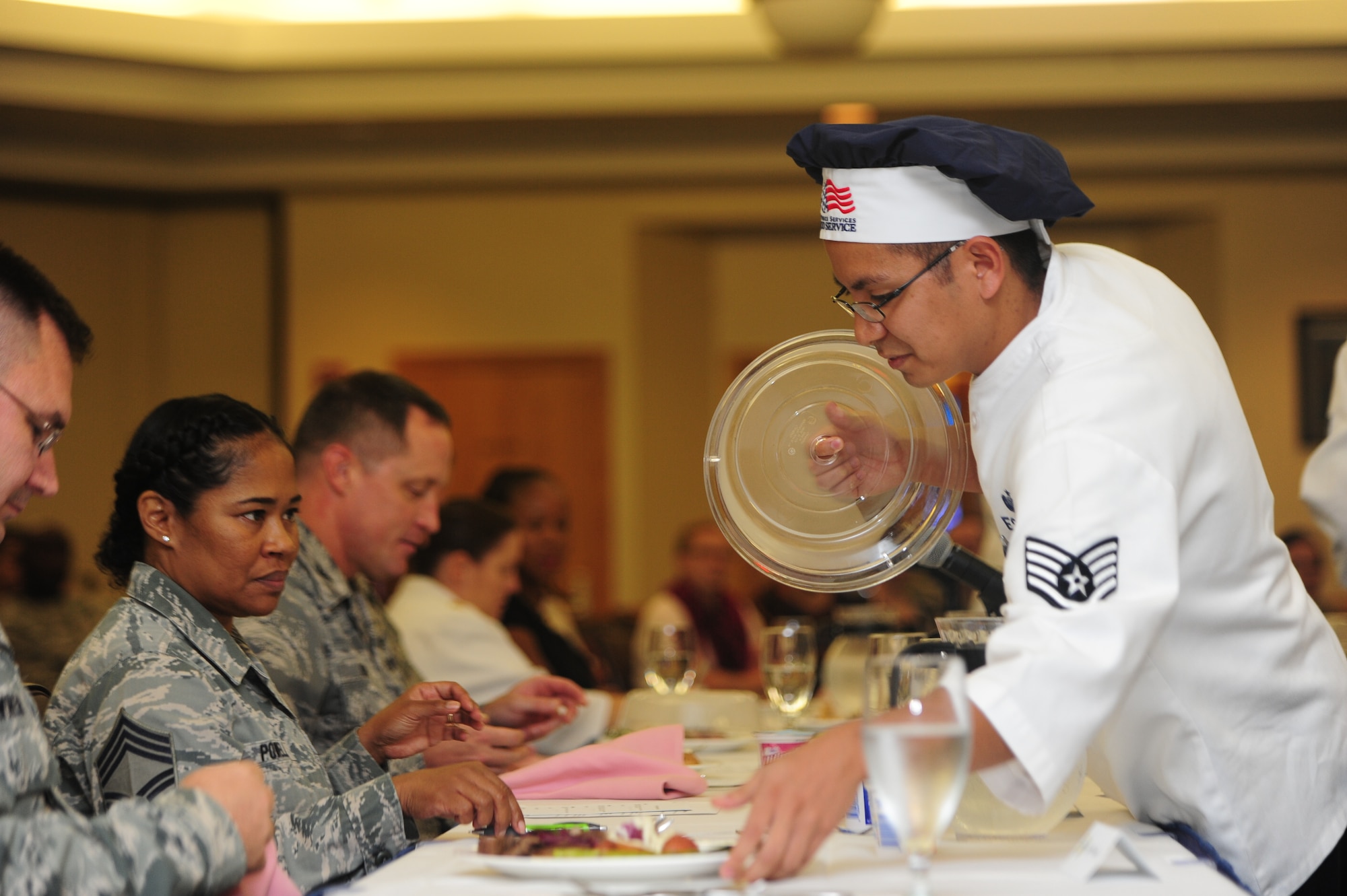 U.S. Air Force Staff Sgt. Renton Espejo, a shift manager for the 509th Force Support Squadron, presents the blue team’s main dish to the judges at the Global Strike Iron Chef Challenge at Whiteman Air Force Base, Mo., Sept. 4, 2015. The red team won the competition and will compete at the major command level at Barksdale AFB, La.
(U.S. Air Force photo by Airman 1st Class Jovan Banks/Released)

