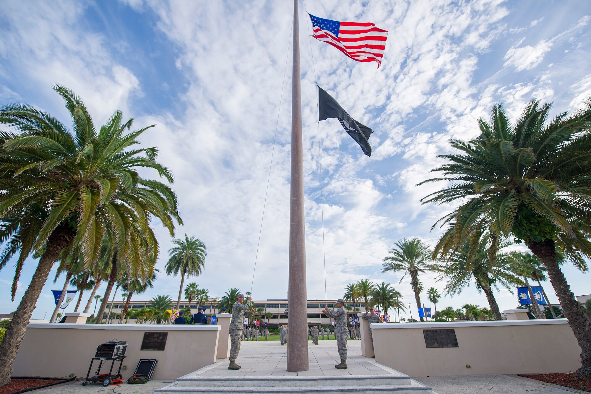 Airmen lower the flag to half-staff during a 9/11/01 remembrance ceremony, Sept. 11, 2015, at Patrick Air Force Base, Fla. Members of Team Patrick-Cape gathered at the base flagpole to honor those who lost their lives 14 years ago on 9/11/01. (U.S. Air Force photos/Matthew Jurgens) (Released) 