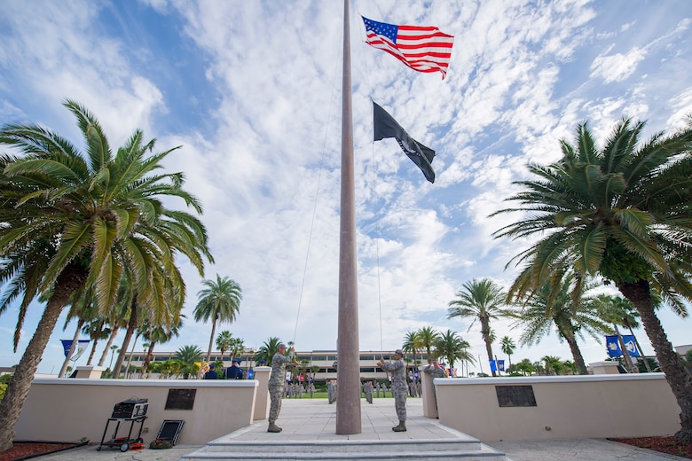Airmen lower the flag to half-staff during a 9/11/01 remembrance ceremony, Sept. 11, 2015, at Patrick Air Force Base, Fla. Members of Team Patrick-Cape gathered at the base flagpole to honor those who lost their lives 14 years ago on 9/11/01. (U.S. Air Force photos/Matthew Jurgens) (Released) 