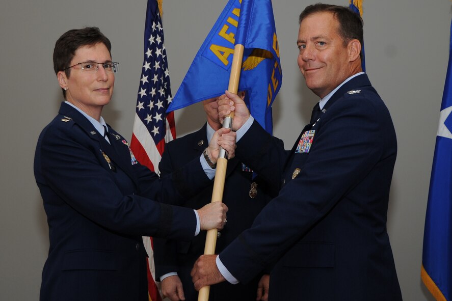 Maj. Gen. Theresa Carter, Air Force Installation and Mission Support Center commander, accepts a guidon from Col. Michael Smith symbolizing his relinquishment of command of the AFIMSC Det. 5 during the change-of-command ceremony on Joint Base Andrews, Md., Sept. 11. AFIMSC delivers globally integrated combat support and shapes the foundation of America's Air, Space, and Cyberspace power. (U.S. Air Force photo/Staff Sgt. Matt Davis)