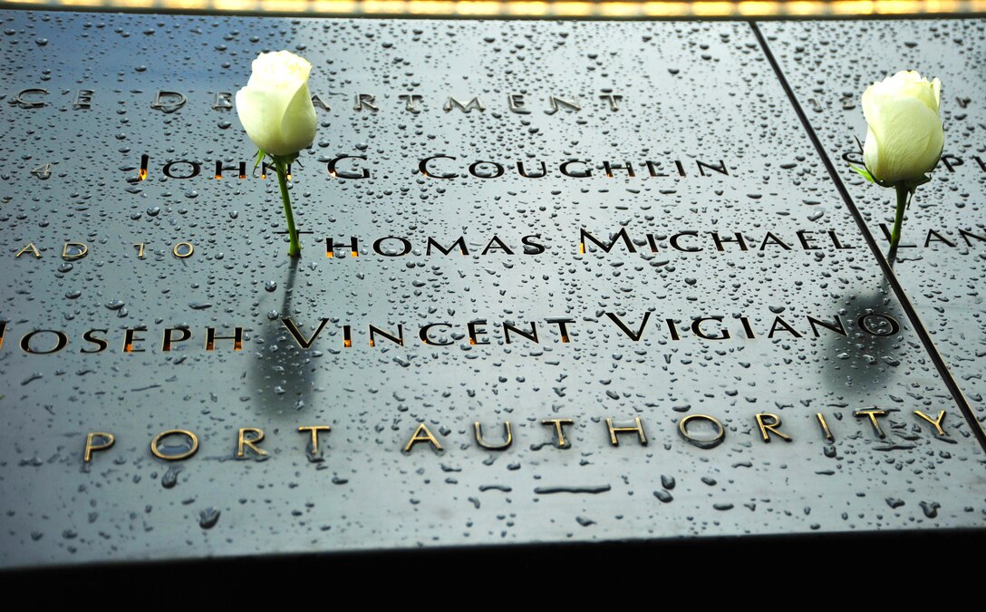 Roses rest on the bronze plates of the National September 11 Memorial in New York City, N.Y. Sept. 10, 2015, just one day before the 14th anniversary of the Sept. 11 attacks. The United States Air Force Honor Guard presented an American Flag folded at the memorial to The Port Authority of New York and New Jersey at a service held on Sept. 11, 2015 to honor the 84 Port Authority employees lost on 9/11. (courtesy photo/Airman 1st Class Latasia Gross)