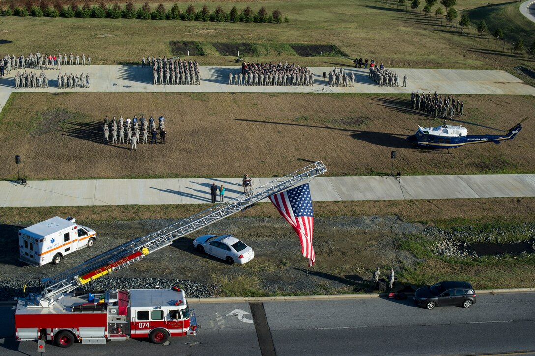 Members of Joint Base Andrews, Md., pay tribute to the first responders and victims of the terrorist attacks on Sept. 11, 2001, during a Patriot's Day Reveille Ceremony at Heritage Park, here, Sept. 11, 2015. (U.S. Air Force photo/Staff Sgt. Nichelle Anderson/released)