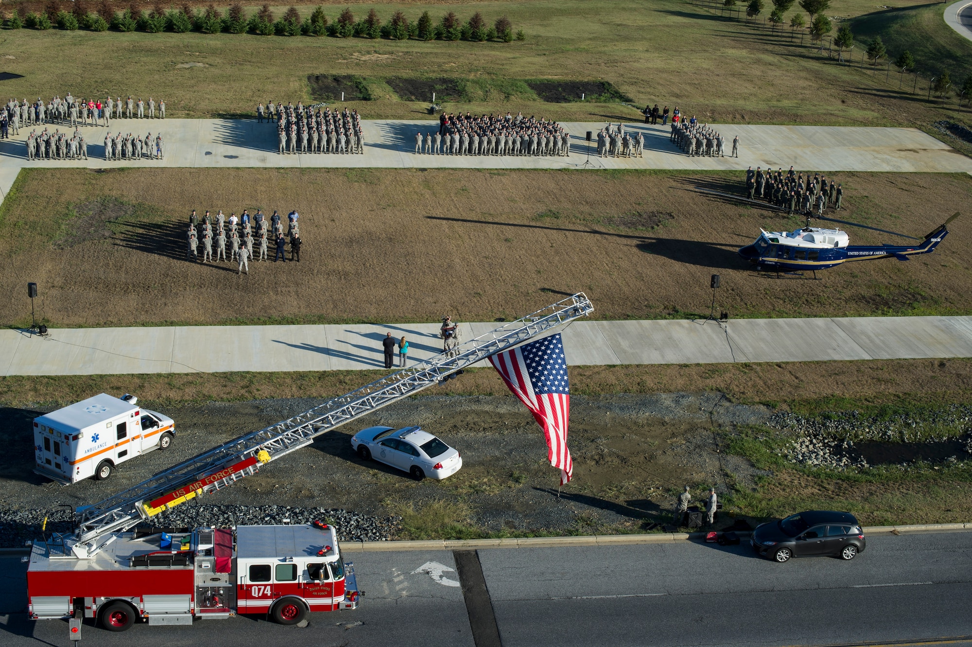 Members of Joint Base Andrews, Md., pay tribute to the first responders and victims of the terrorist attacks on Sept. 11, 2001, during a Patriot's Day Reveille Ceremony at Heritage Park, here, Sept. 11, 2015. (U.S. Air Force photo/Staff Sgt. Nichelle Anderson/released)