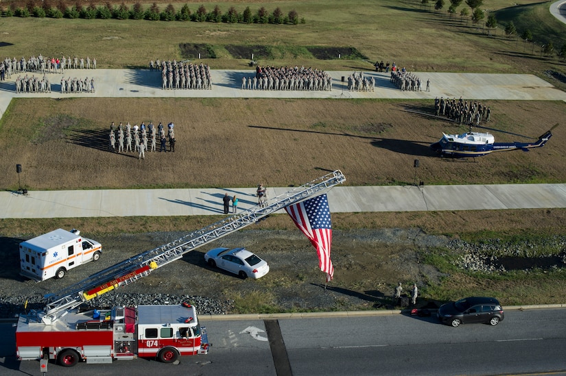 Members of Joint Base Andrews, Md., pay tribute to the first responders and victims of the terrorist attacks on Sept. 11, 2001, during a Patriot's Day Reveille Ceremony at Heritage Park, here, Sept. 11, 2015. (U.S. Air Force photo/Staff Sgt. Nichelle Anderson/released)