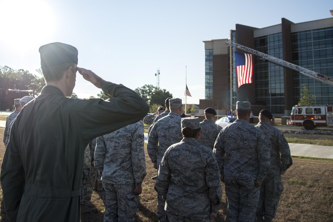 First responders salute during a Patriot's Day Reveille Ceremony at Heritage Park, Joint Base Andrews, Md., Sept. 11, 2015. The paid tribute to the first responders and victims of the terrorist attacks on Sept. 11, 2001. (U.S. Air Force photo by Airman 1st Class Philip Bryant/released) 
