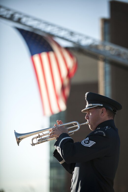 Tech. Sgt. Matthew Miser, U.S. Air Force Band’s Ceremonial Brass trumpeter, plays Taps during a Patriot's Day Reveille Ceremony at Heritage Park, Joint Base Andrews, Md., Sept. 11, 2015. The ceremony paid tribute to the first responders and victims of the terrorist attacks on Sept. 11, 2001. (U.S. Air Force photo by Airman 1st Class Philip Bryant/released) 