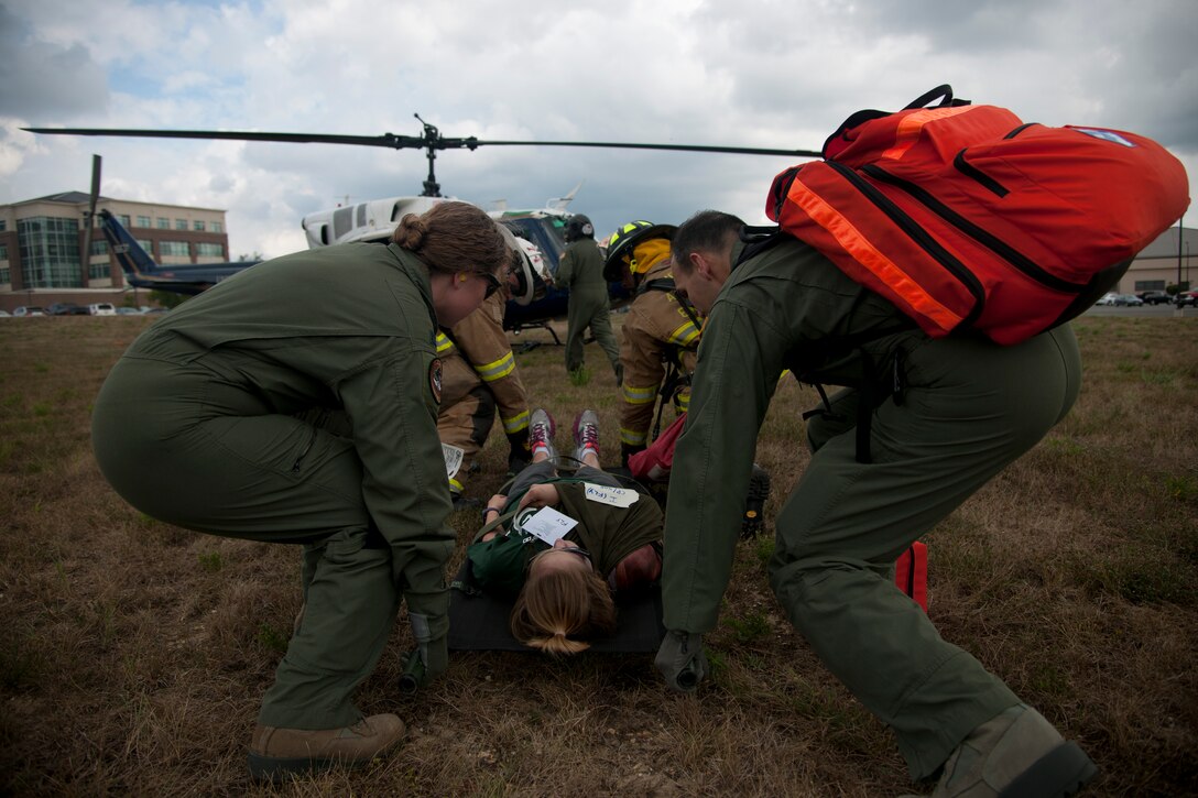 Members of the 1st Helicopter Squadron carry a litter to a UH-1N Twin Huey at Joint Base Andrews, Md., Sept. 10, 2015. The exercise tested a variety of preparedness aspects including first response and transporting patients to ambulances and helicopters. (U.S. Air Force photo/ Airman 1st Class J.D. Maidens/released)