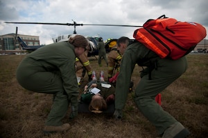 Members of the 1st Helicopter Squadron carry a litter to a UH-1N Twin Huey at Joint Base Andrews, Md., Sept. 10, 2015. The exercise tested a variety of preparedness aspects including first response and transporting patients to ambulances and helicopters. (U.S. Air Force photo/ Airman 1st Class J.D. Maidens/released)