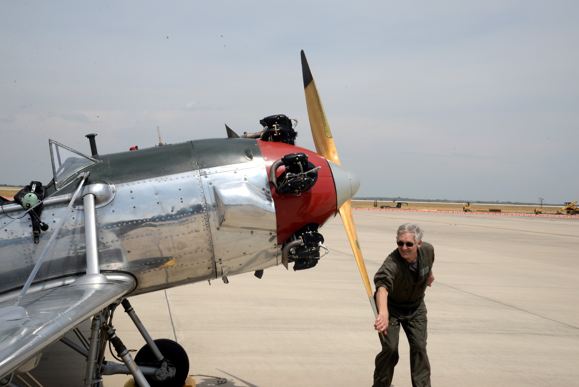 Dick Keyt, former Air Force pilot and owner of the Ryan PT-22 Recruit, adjusts his aircraft’s propeller on Laughlin Air Force Base, Texas, Sept. 10, 2015. Keyt, an instuctor pilot, made the three-hour flight from Fort Worth, Texas, to attend a former student’s graduation. (U.S. Air Force Photo by Airman 1st Class Brandon May) (Released)