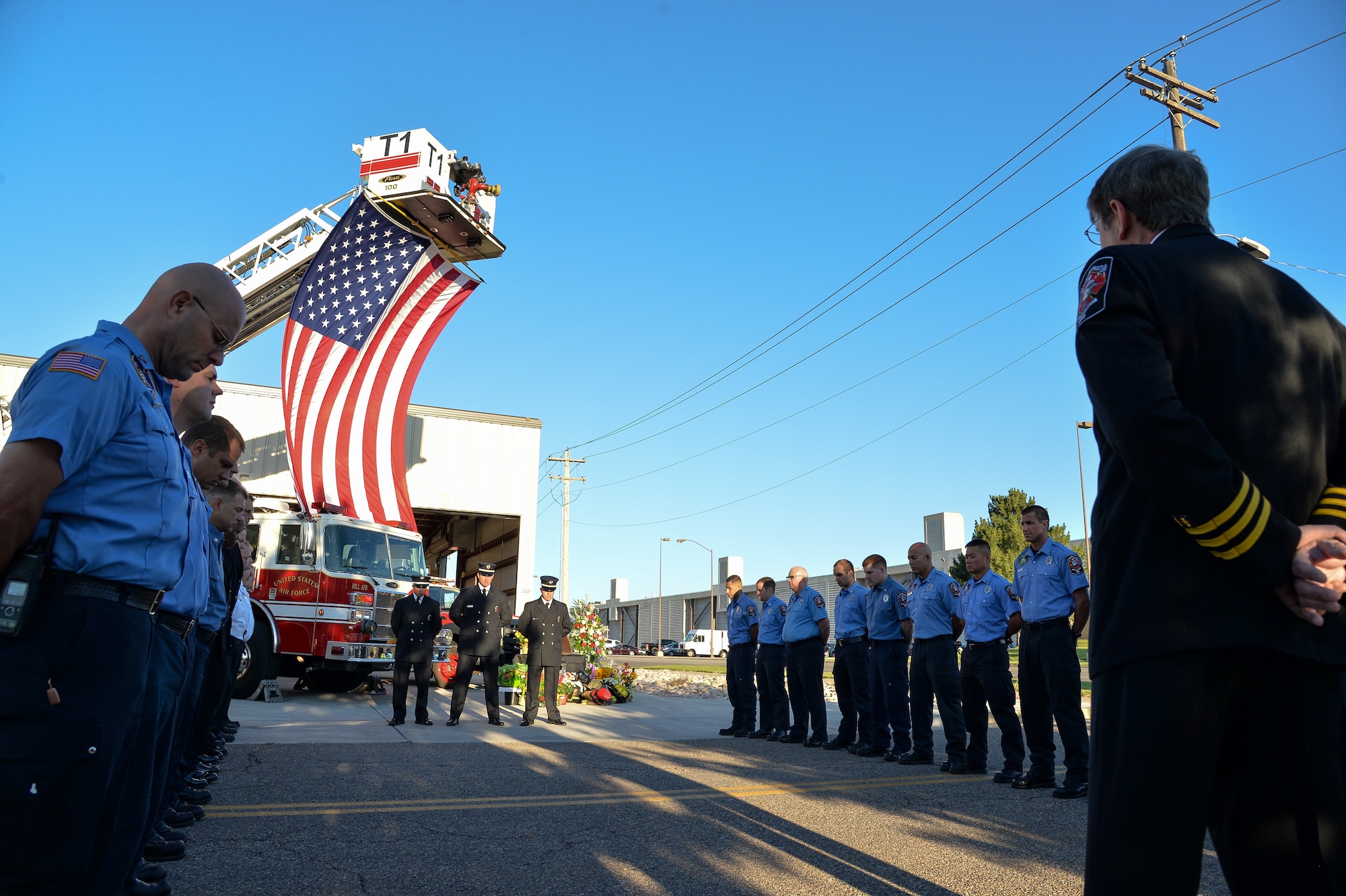 Team Hill firefighters bow their heads during a moment of silence at a 9/11 observance ceremony in front of Fire Station No. 1, Hill Air Force Base, Utah, Friday, Sept. 11, 2015. This Friday marks the 14th anniversary of the terrorist attacks on the Pentagon and the World Trade Center Towers. (U.S. Air Force photo by R. Nial Bradshaw)