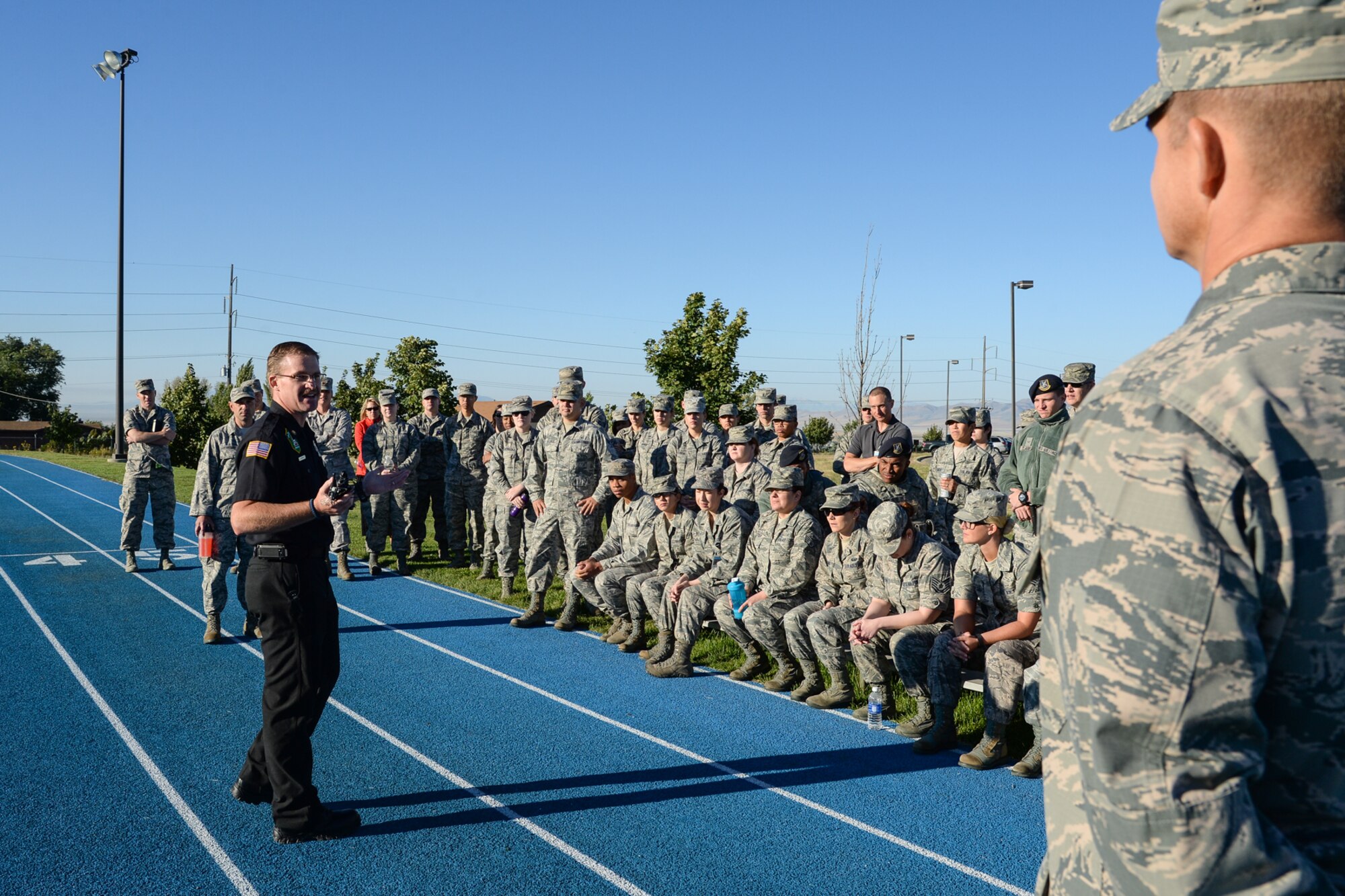 Battalion Chief Jeff Herriott, 775th Civil Engineering Squadron, instructs Airman assigned to 75th Medical Group about implementating a landing zone for an air evacuation during a training and familiarization event, Sept. 9, 2015. (U.S. Air Force photo by R. Nial Bradshaw)