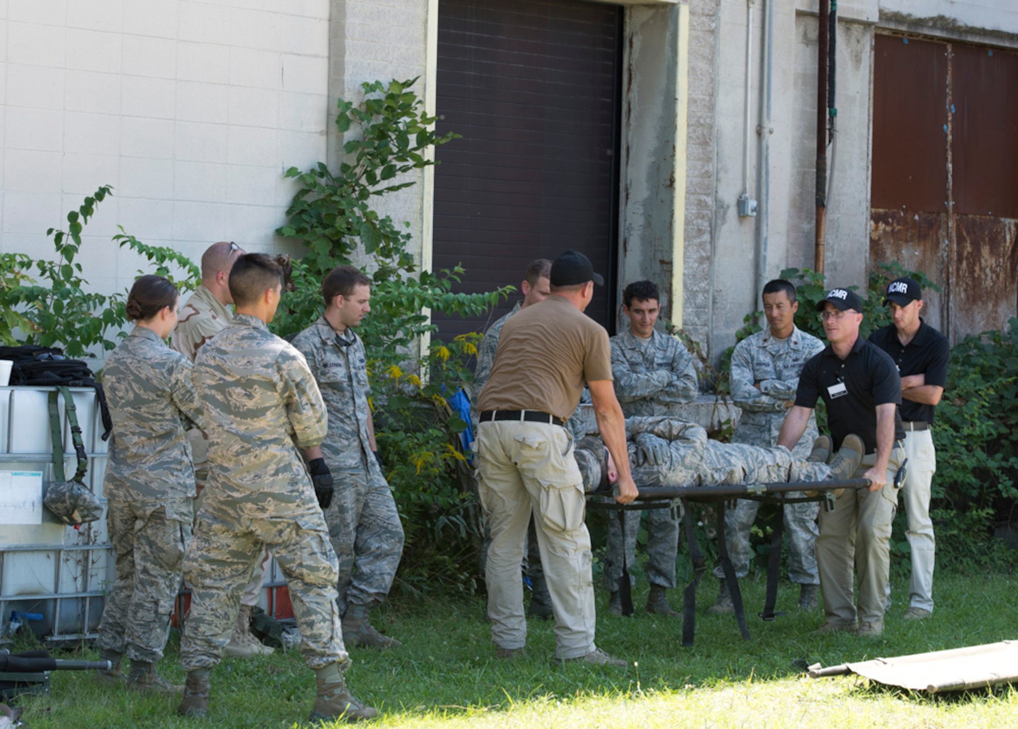 Participants in the Air Force Research Laboratory 2015 Tech Warrior exercise learn some of the basics of safely transporting a wounded service member on a stretcher, Sept. 10, 2015, at the National Center for Medical Readiness, Fairborn, Ohio. During the exercise participants are learning a variety of skills such as base defense, self-aide buddy care, tactical vehicle driving and land navigation. (U.S. Air Force photo by Wesley Farnsworth / Released)