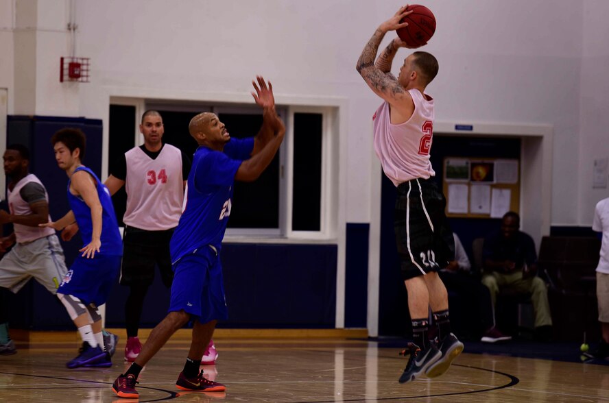 U.S. Air Force Staff Sgt. George Covington, 35th Aircraft Maintenance Squadron NCO in charge of personnel command support staff, shoots a basketball at Misawa Air Base, Japan, Sept. 6, 2015. The game ended with the Aomori Wats in the lead with a score of 81-69. (U.S. Air Force photo by Airman 1st Class Jordyn Fetter/Released)
